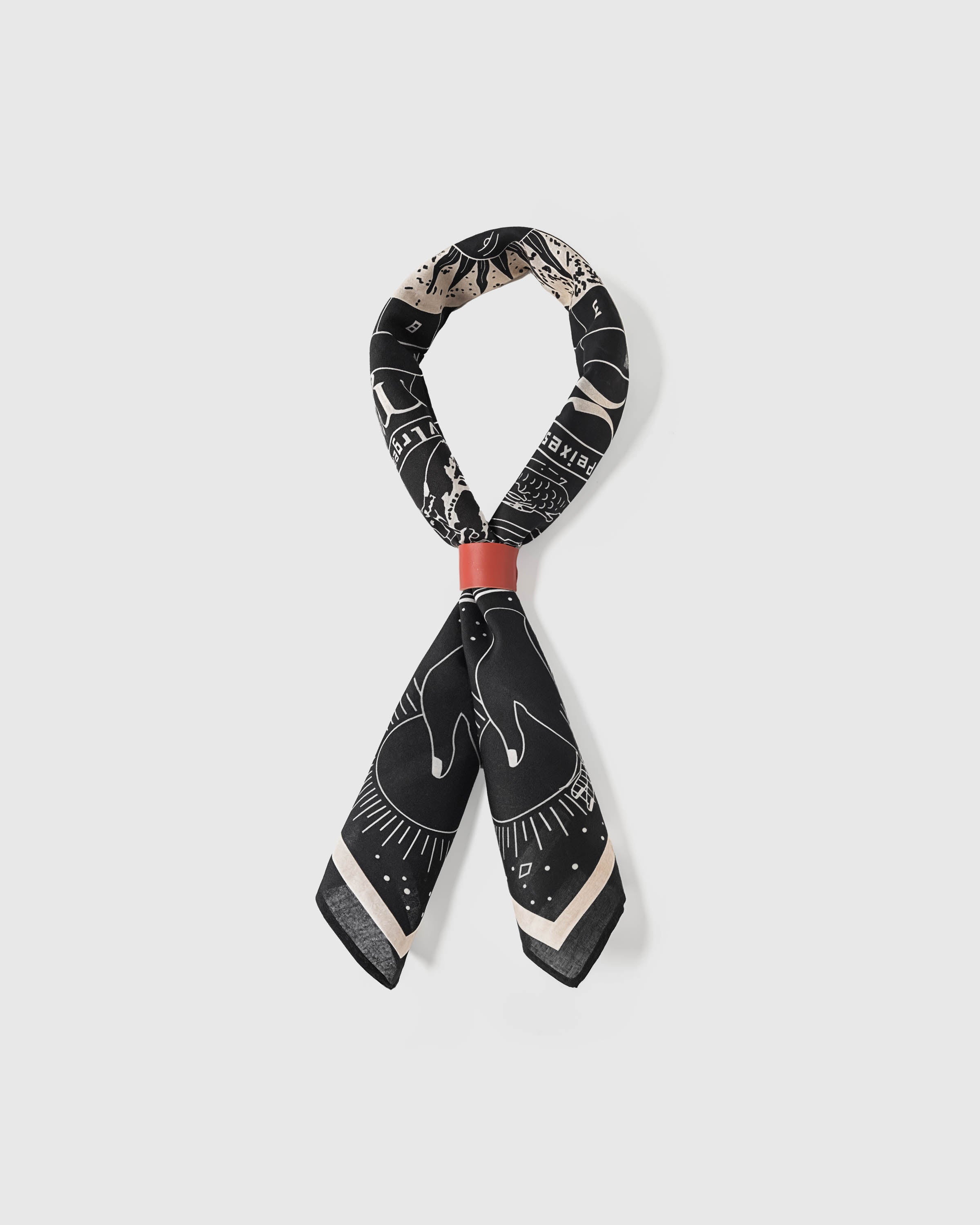 STICKYZOO zodiac wheel silk scarf looped through a scarf ring showing the celestial print and silk drape