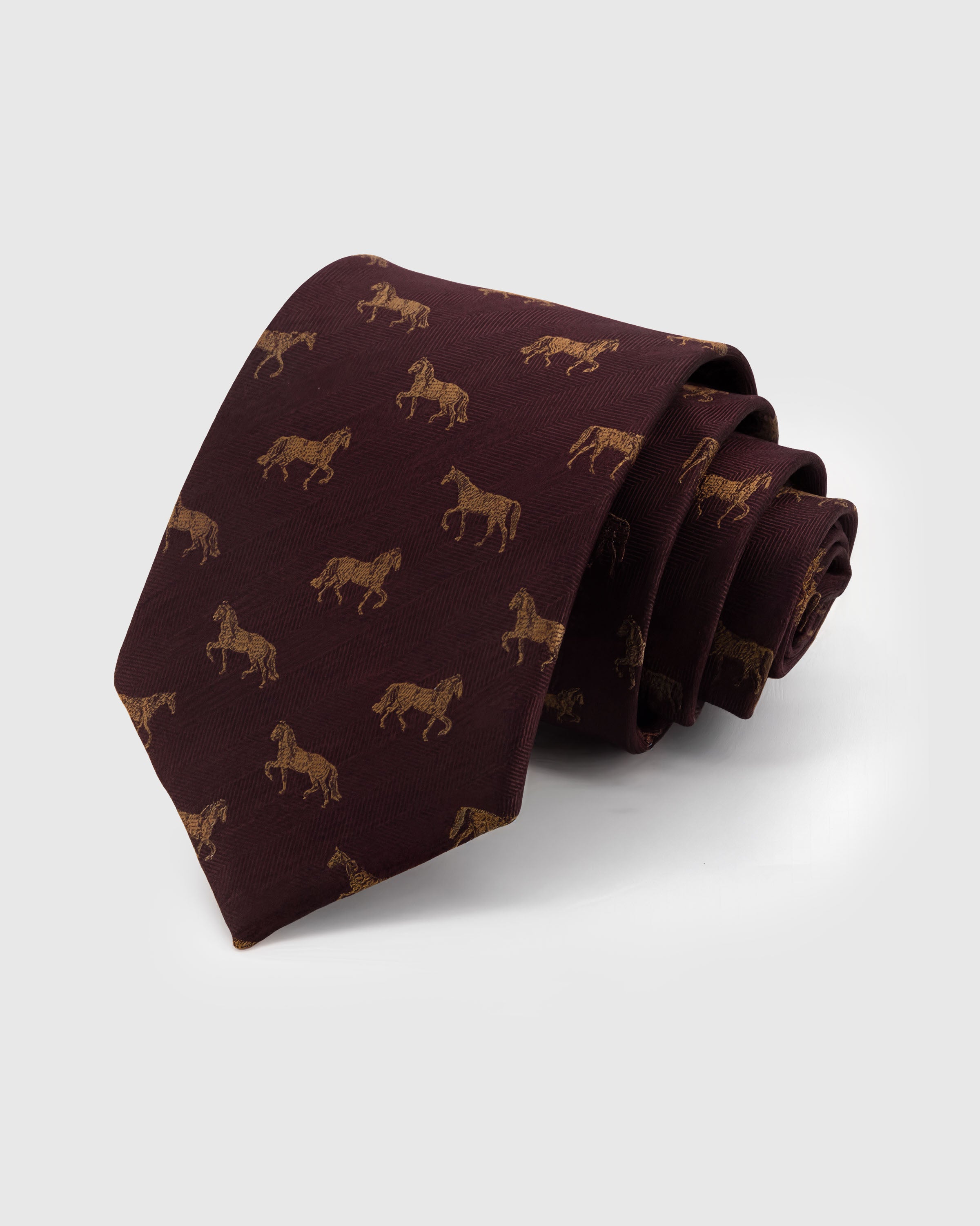 STICKYZOO Garnet Stallion Tie in hand-embroidered mulberry silk with amber stallion motifs on garnet herringbone ground, 45° bias-cut Italian method