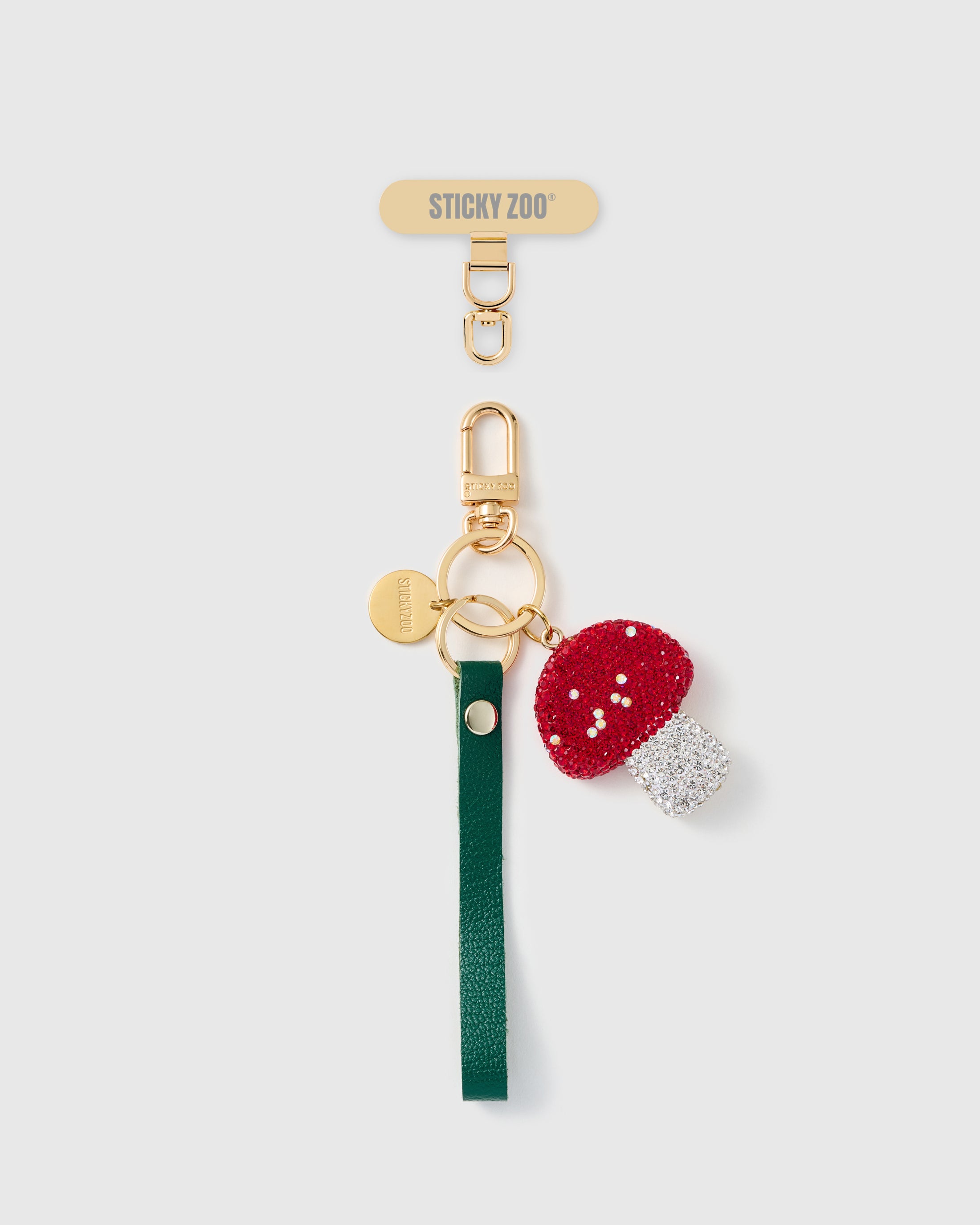 Handmade French Alran forest green leather phone strap with red and clear crystal-pavé mushroom charm and 18K gold STICKYZOO hardware