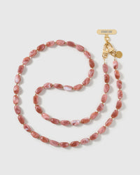 Full-length STICKYZOO cross-body phone strap strung with high-gloss dusty-rose resin nugget beads in a warm blush swirl