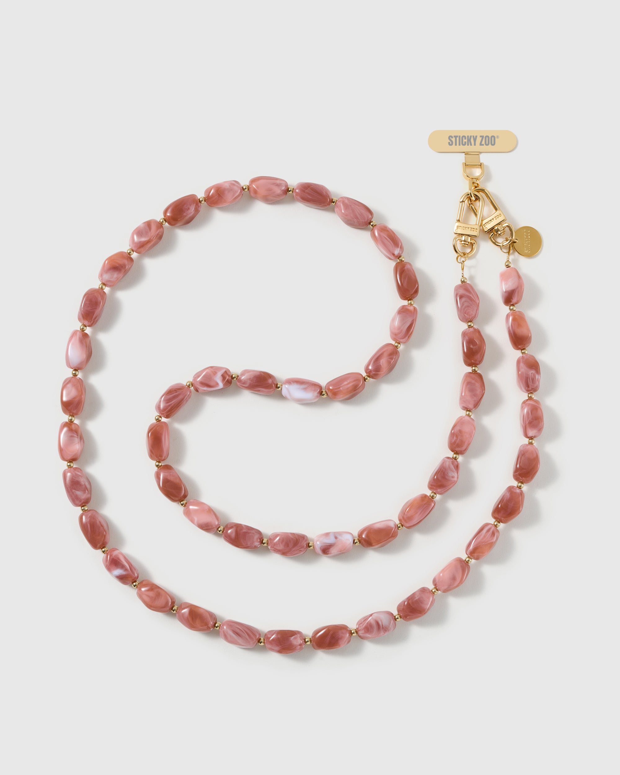 Full-length STICKYZOO cross-body phone strap strung with high-gloss dusty-rose resin nugget beads in a warm blush swirl