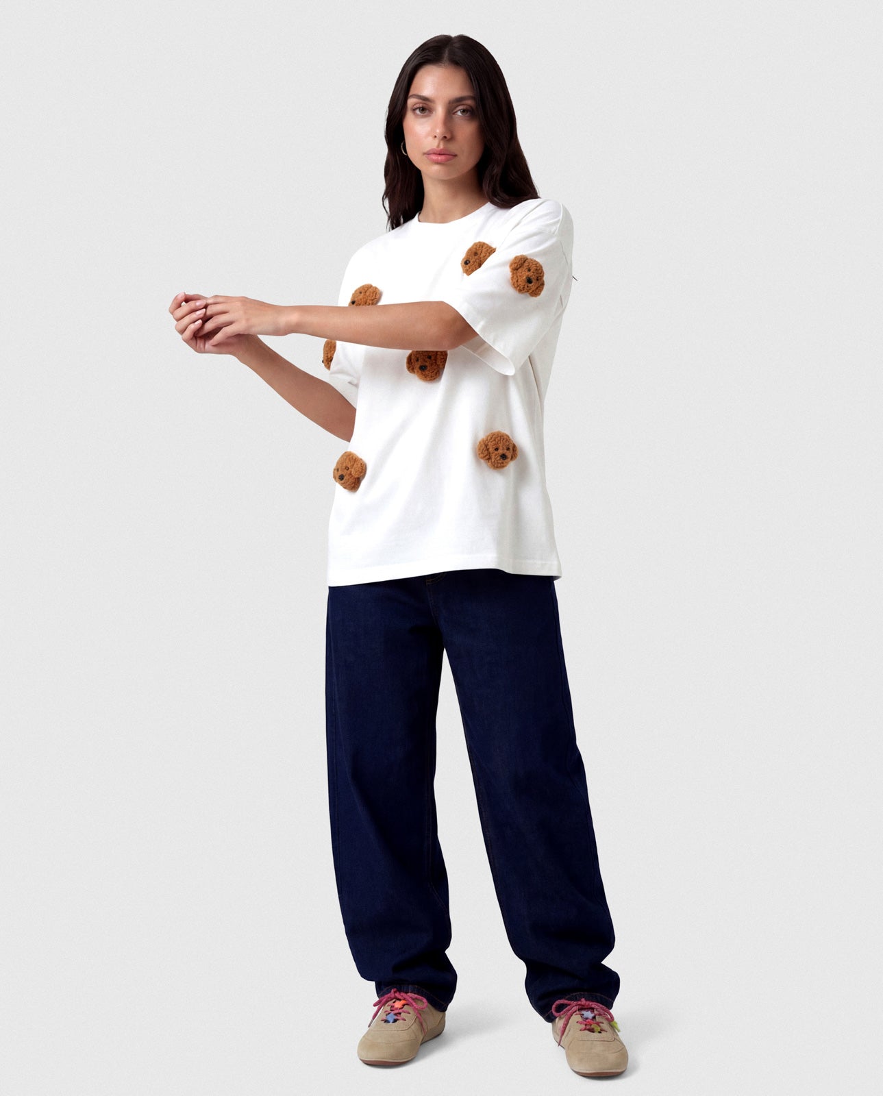 Model wearing white STICKYZOO Poodle Parade T-Shirt showing dropped shoulders and plush poodles
