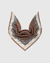 Chestnut silk scarf in a soft drape showing the white floret field and baroque navy paisley border