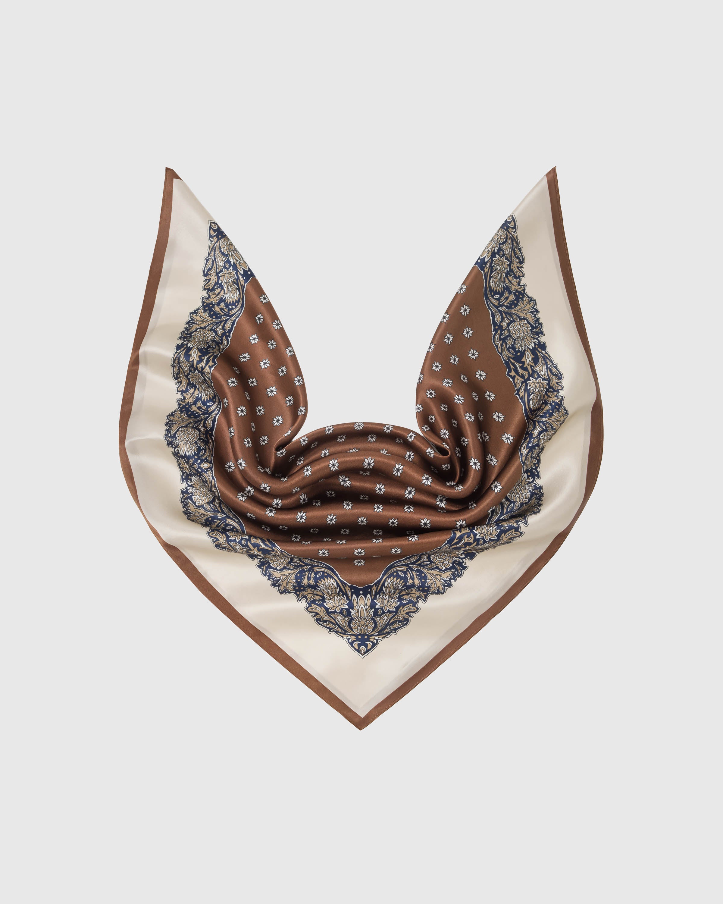 Chestnut silk scarf in a soft drape showing the white floret field and baroque navy paisley border