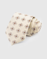 STICKYZOO Ivory Medallion Tie in hand-embroidered mulberry silk with sienna quatrefoil medallions on textured cream ground, 45° bias-cut
