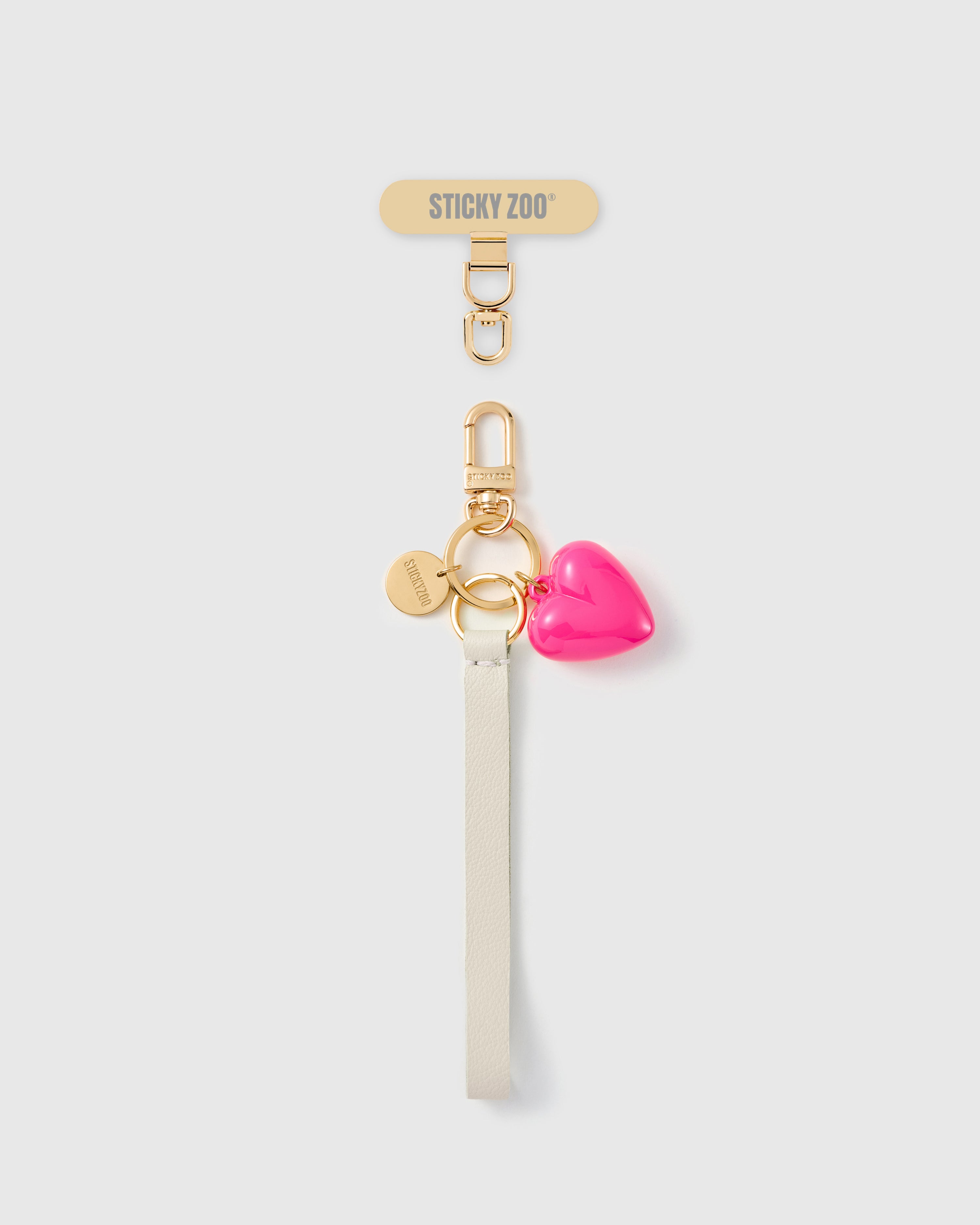 Handmade French Alran ivory leather phone strap with glossy hot pink puff heart charm and 18K gold STICKYZOO hardware