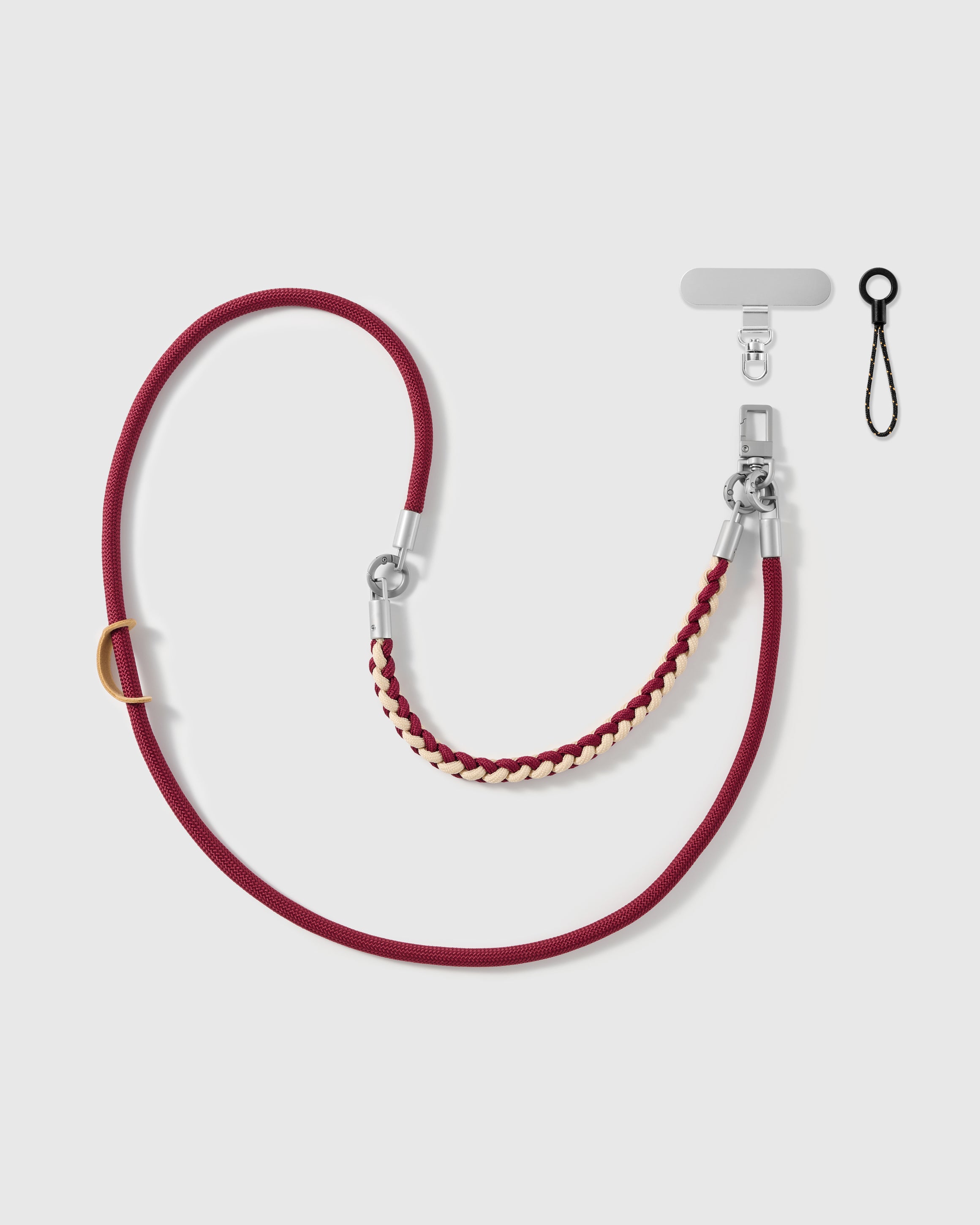 Bordeaux braided phone strap by STICKYZOO, worn as a wrist strap or cross-body, with silver-tone swivel hooks, a phone-tab connector and safety tether