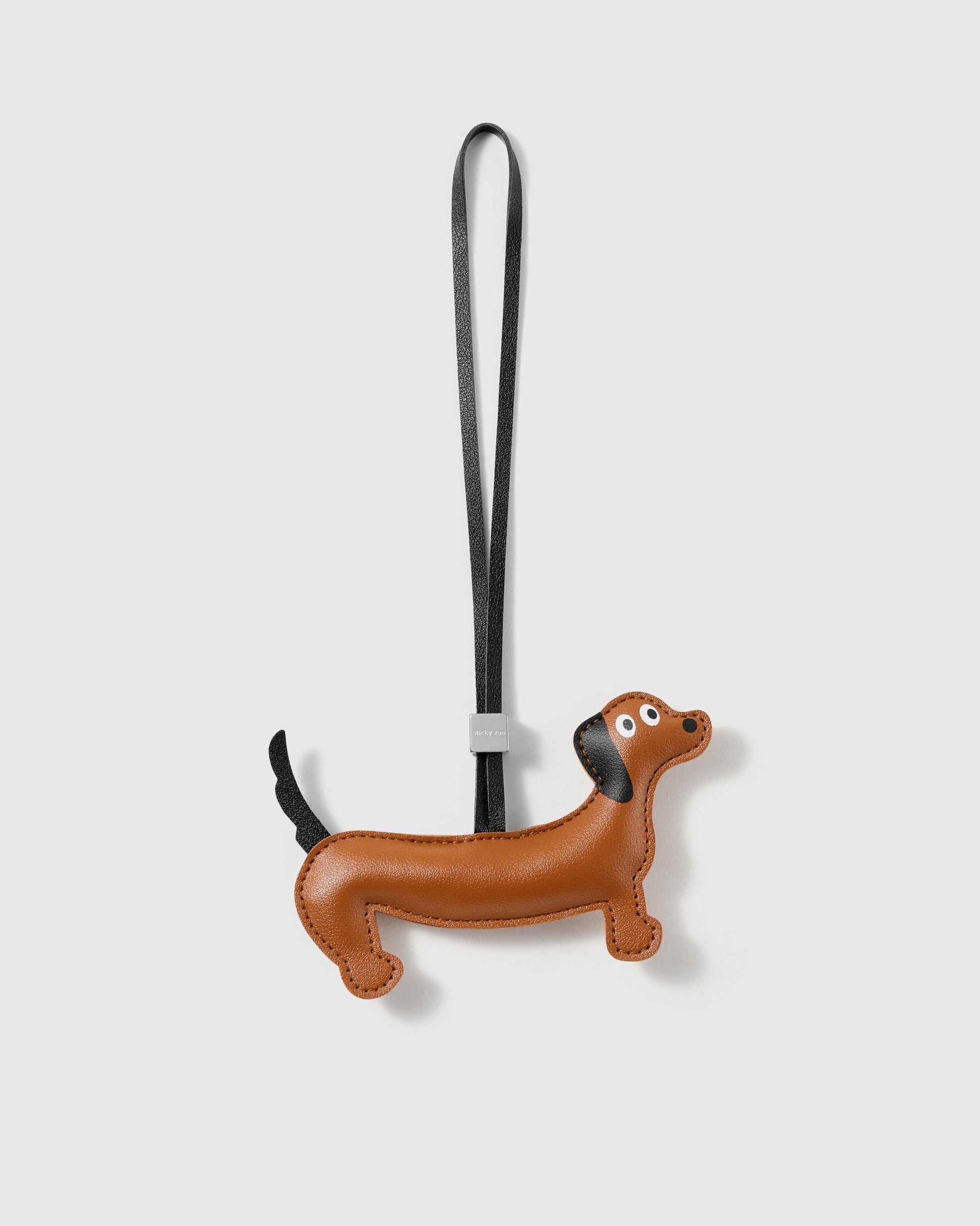Handmade French Alran leather dachshund bag charm with engraved 18K gold-plated hardware by STICKYZOO