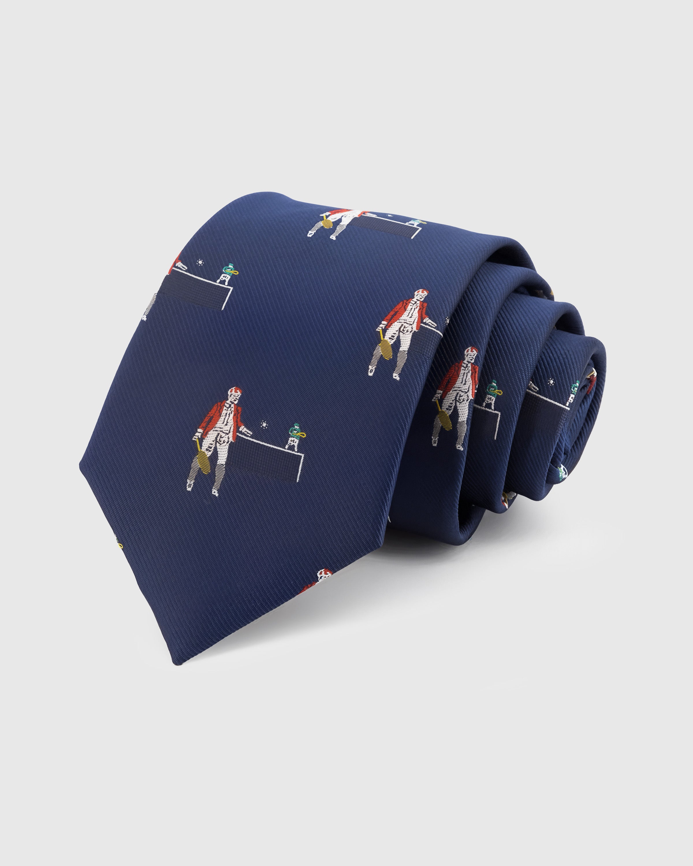 NAVY TENNIS TIE — Hand-embroidered tennis figure detail on 100% mulberry silk in navy, showing embroidery texture and silk sheen