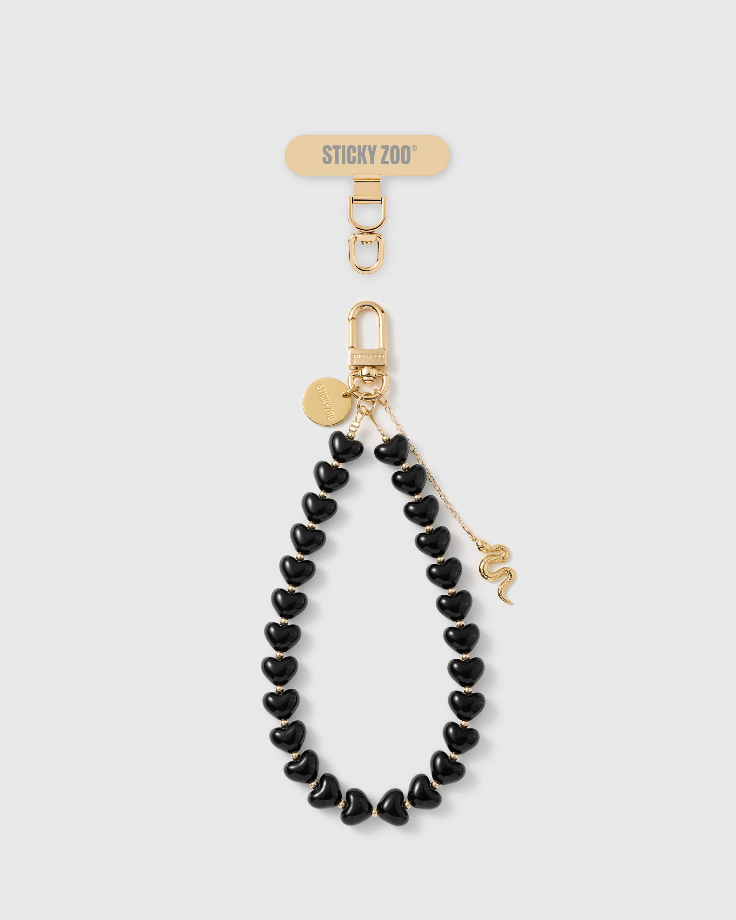 Rated 4.9 stars STICKYZOO noir snake heart phone strap with engraved gold snake charm on fine drop chain and glossy noir heart beads
