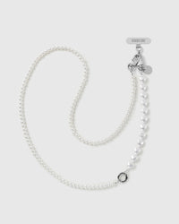 STICKYZOO white faux-pearl crossbody phone strap laid flat, round pearls running into a run of puffy heart beads, with silver-tone clasps and O-ring.