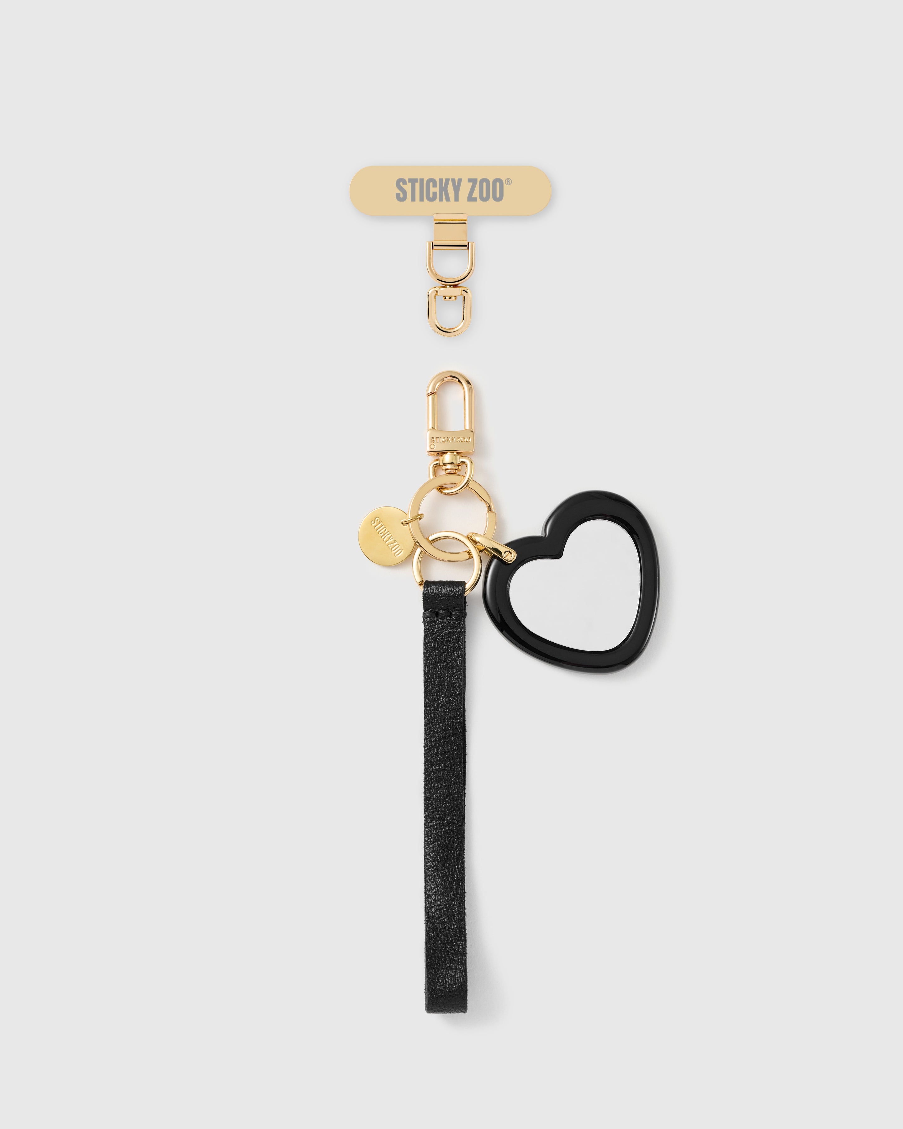 Handmade French Alran black leather phone strap with heart-shaped pocket mirror and 18K gold STICKYZOO hardware