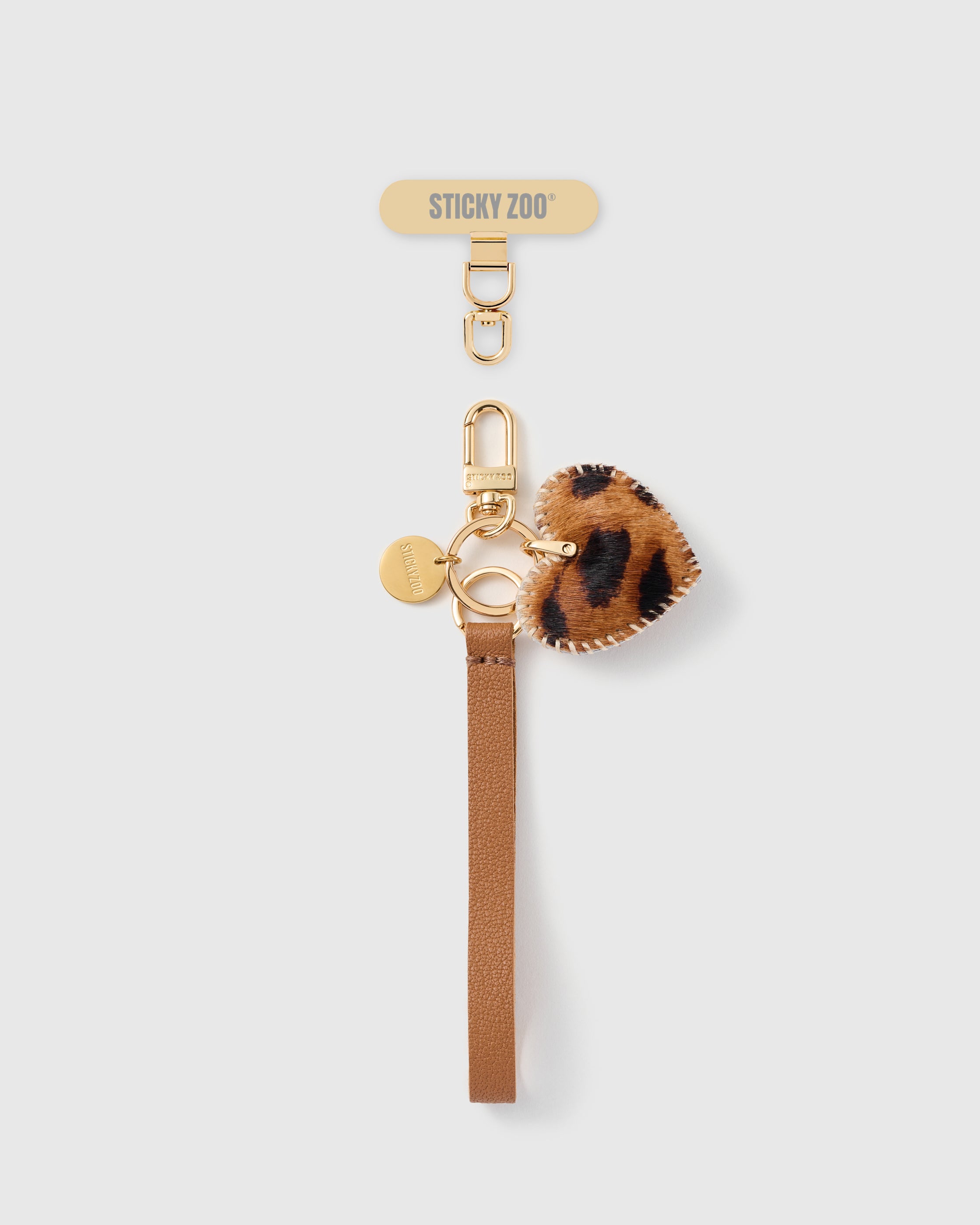 STICKYZOO cognac leopard heart leather phone strap flat, calf-hair heart charm on pebbled Alran leather with gold hook