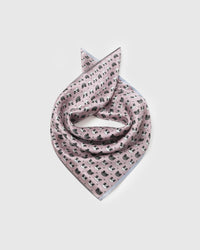 Blush pink silk panda scarf coiled into a soft bandana fold showing the panda scatter