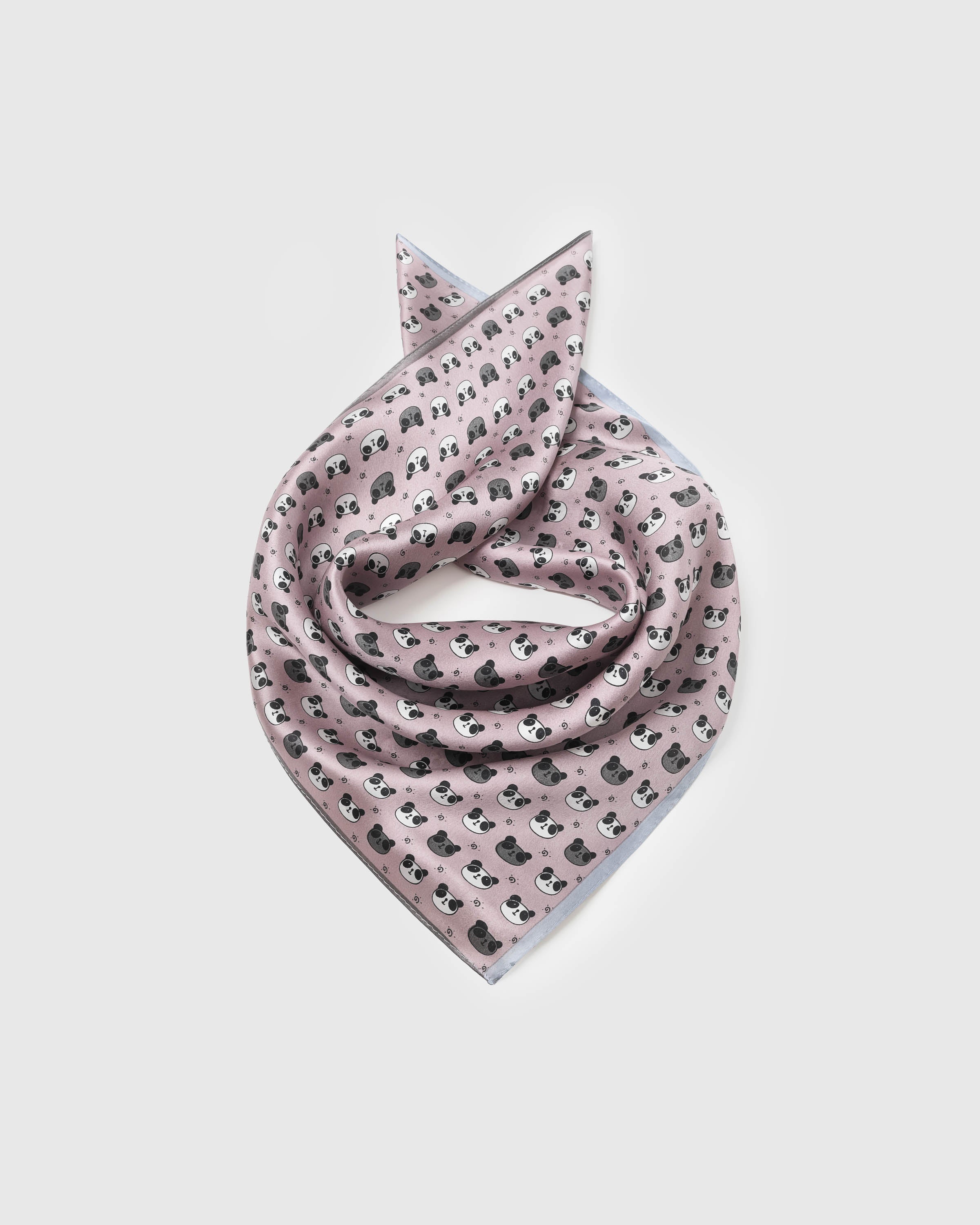 Blush pink silk panda scarf coiled into a soft bandana fold showing the panda scatter
