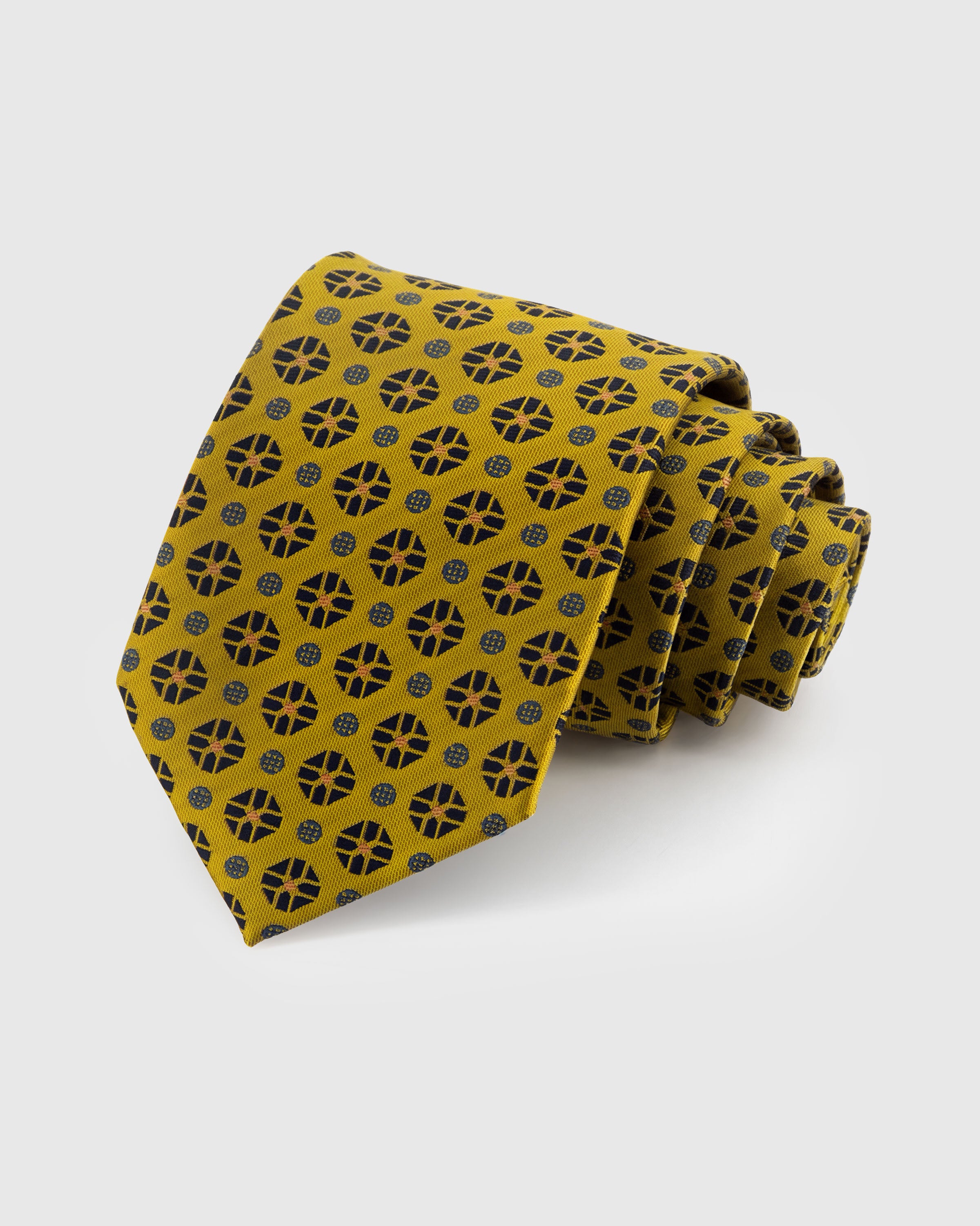 STICKYZOO AMBER MEDALLION TIE — 100% mulberry silk with hand-embroidered ornate compass-style medallion motifs on rich amber gold ground