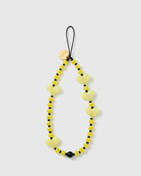 STICKYZOO Lemon Heart phone strap flat: pale yellow glossy heart beads, yellow-and-white striped beads and black spacers on a black cord loop with gold disc