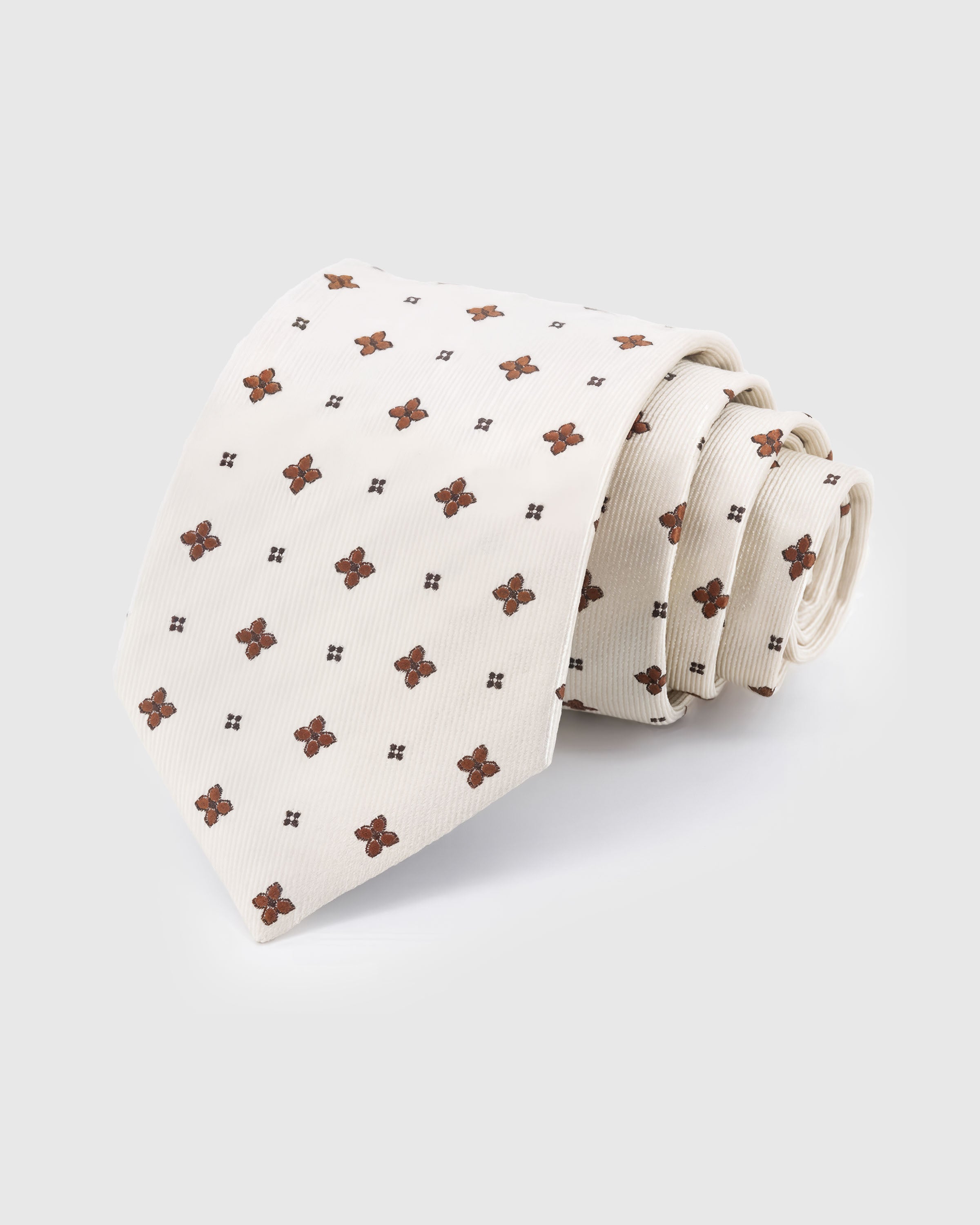 STICKYZOO Ivory Clover Tie — hand-embroidered ivory / copper mulberry silk with spaced clover motif pattern