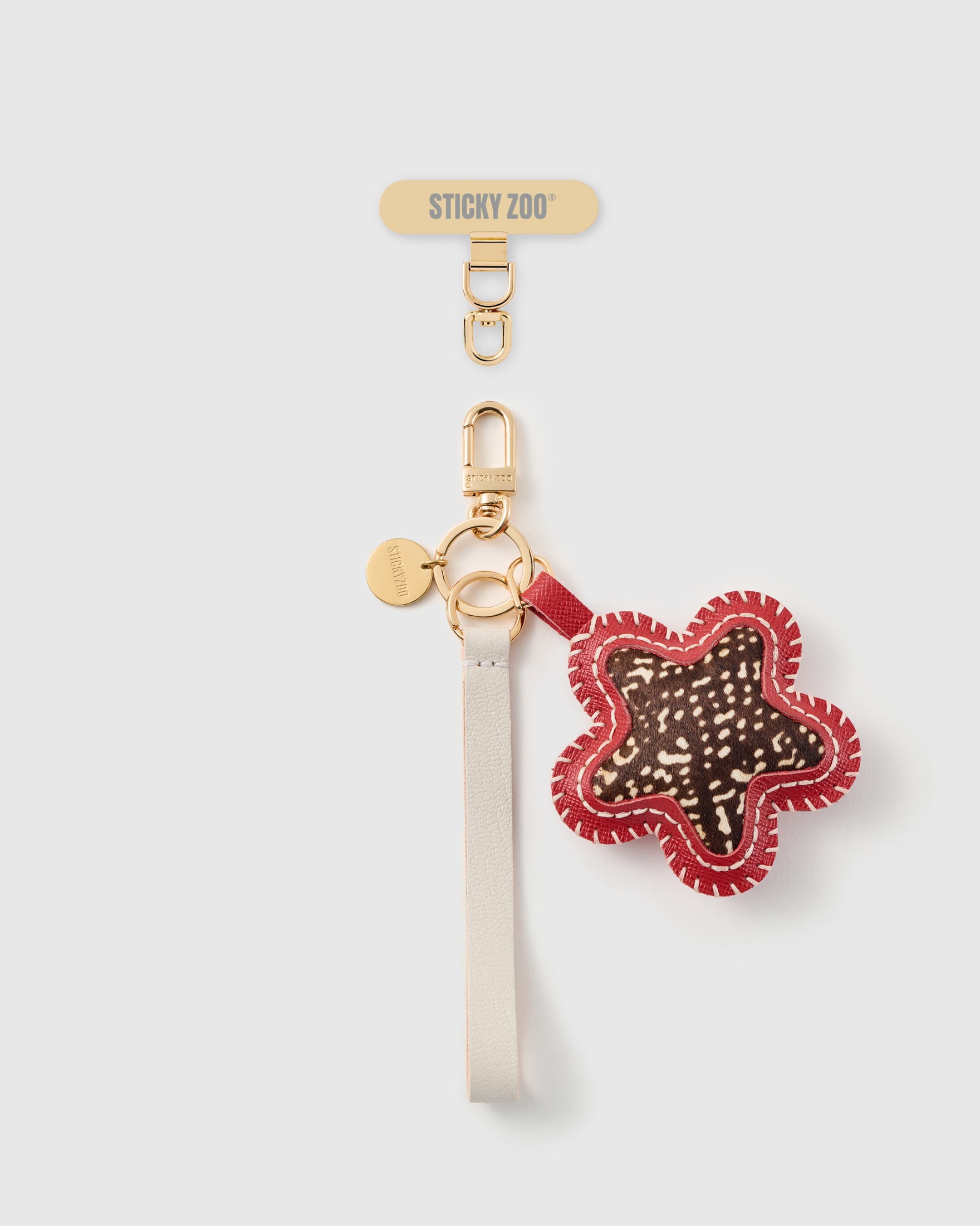 STICKYZOO ocelot star leather phone strap, ivory strap with speckled calf-hair star and gold hook