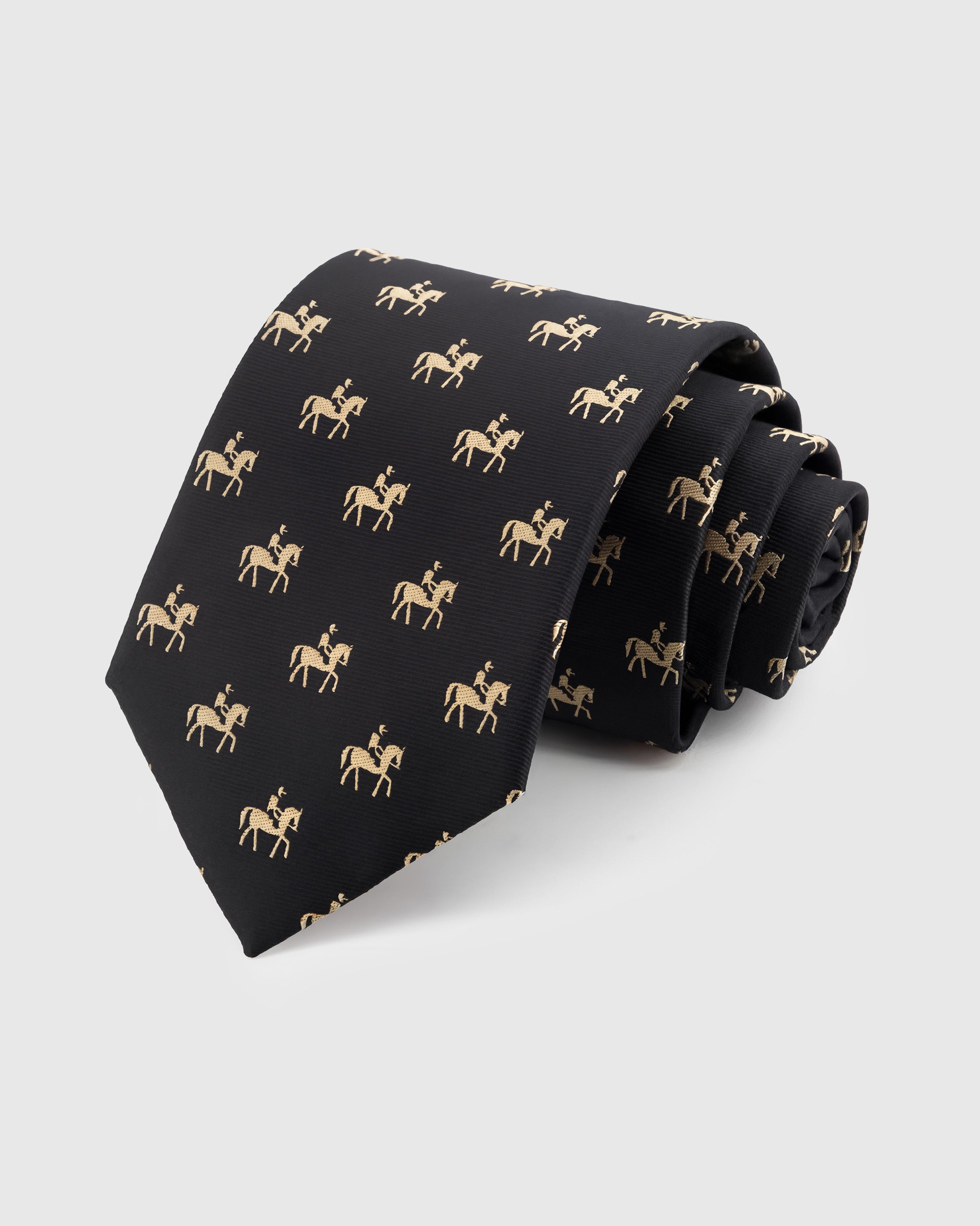 ONYX EQUESTRIAN TIE — Hand-embroidered equestrian detail on 100% mulberry silk in onyx, showing embroidery texture and silk sheen