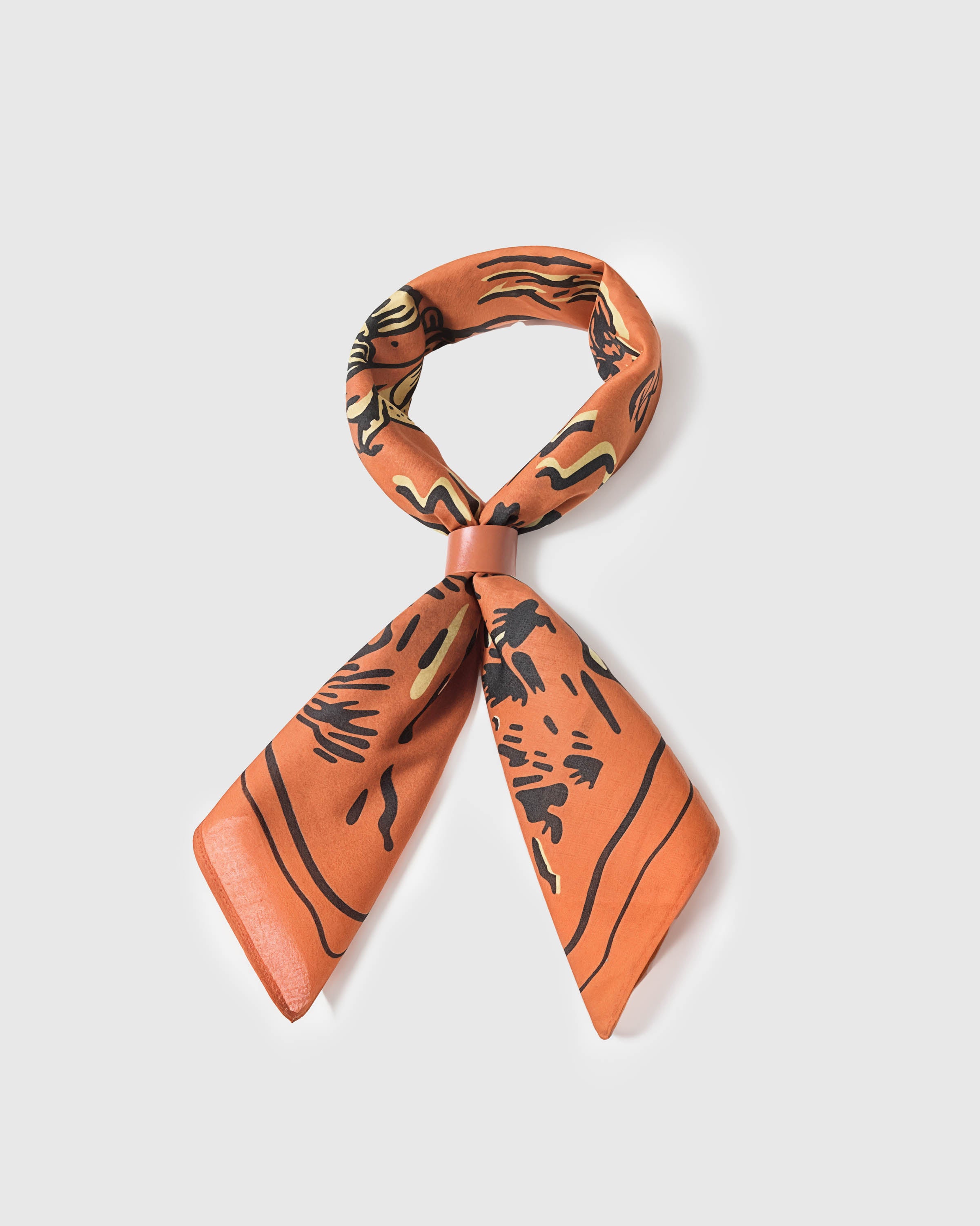 River trout silk scarf looped through a ring showing the soft drape and saturated burnt-orange print