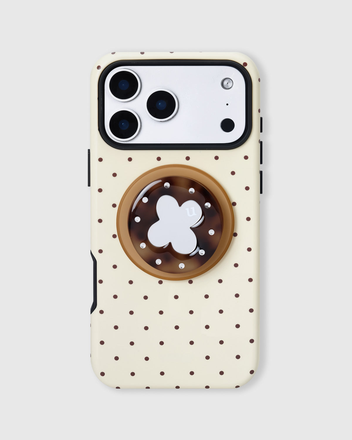 Buttercream phone case with chocolate polka dots and a tortoiseshell MagSafe grip with silver clover by STICKYZOO