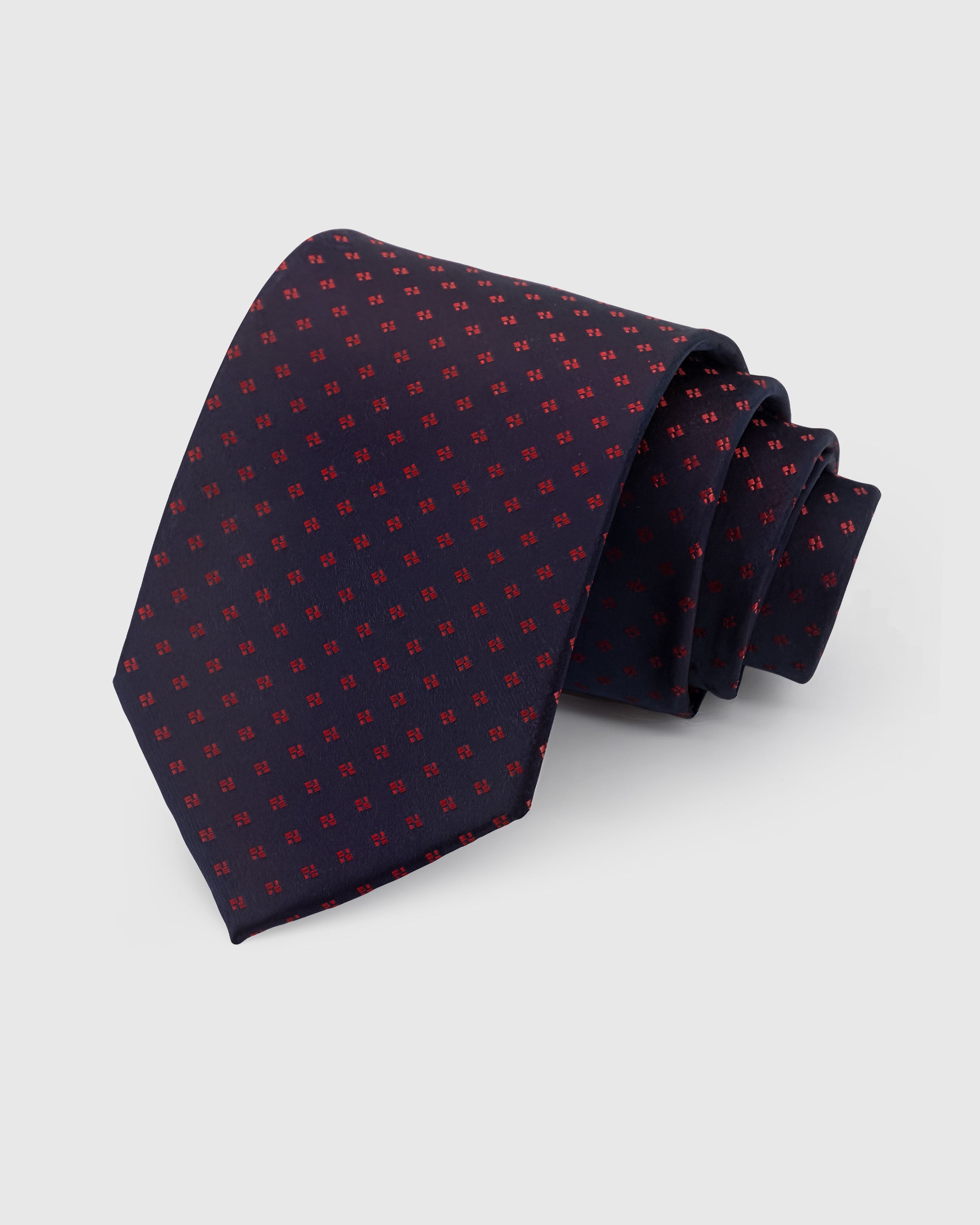 {{100% mulberry silk}} STICKYZOO Midnight Micro Tie in hand-embroidered mulberry silk with crimson micro-geometric motifs on navy ground