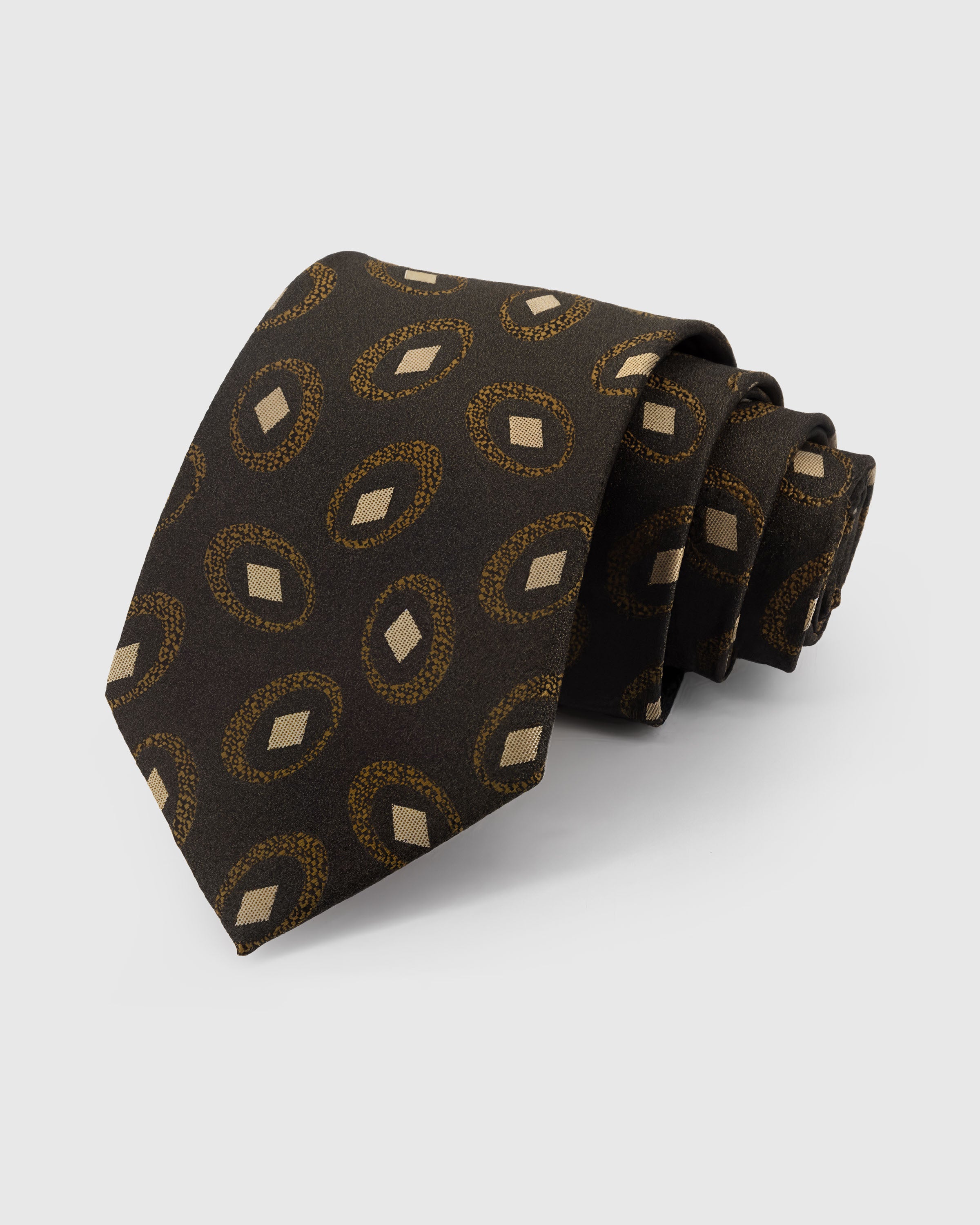 STICKYZOO Umber Medallion Tie in hand-embroidered mulberry silk with gold medallion circles on umber ground, 45° bias-cut Italian method