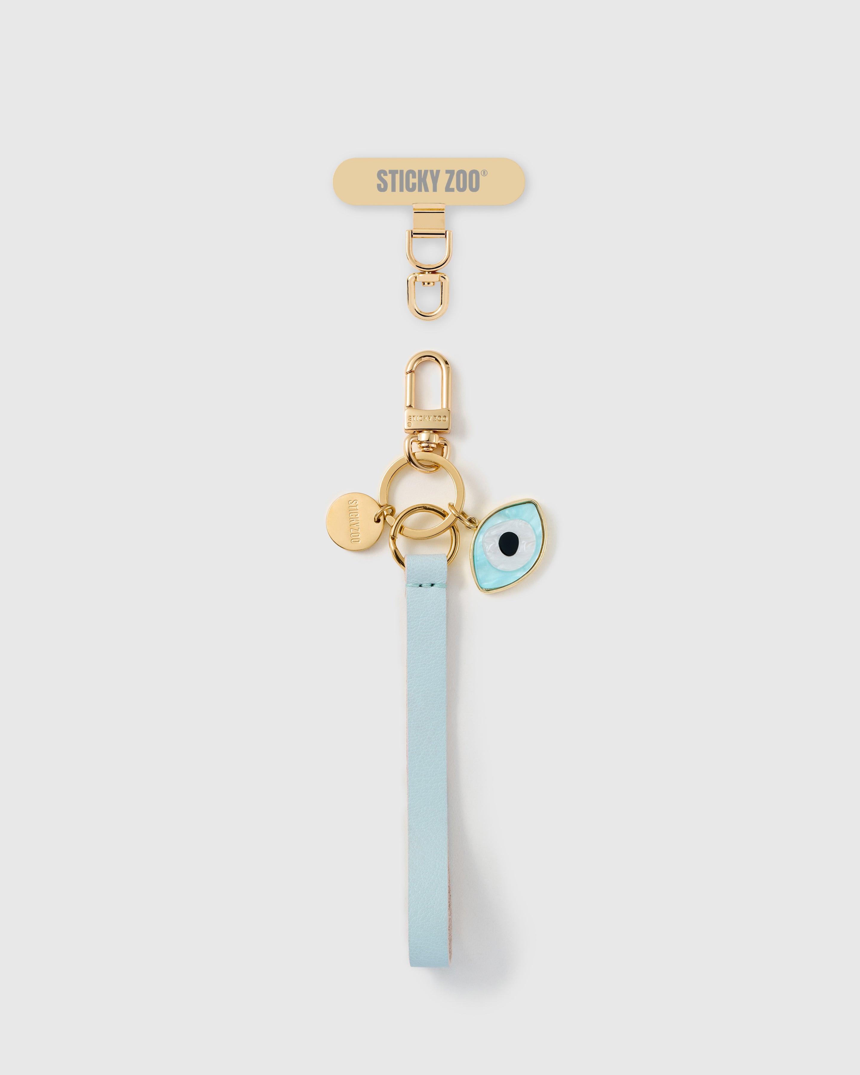Handmade French Alran sky blue leather phone strap with mother-of-pearl mati amulet and 18K gold STICKYZOO hardware