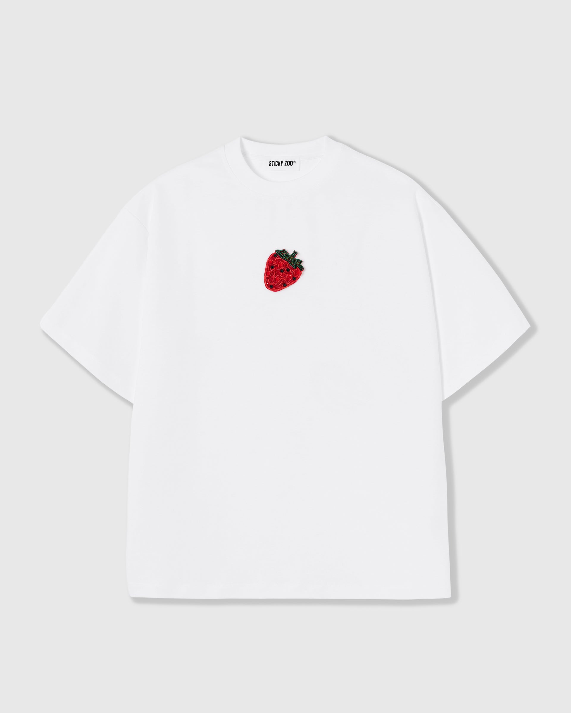 STICKYZOO Strawberry T-Shirt in white, oversized boxy fit with the same hand-beaded glass strawberry on the left chest.