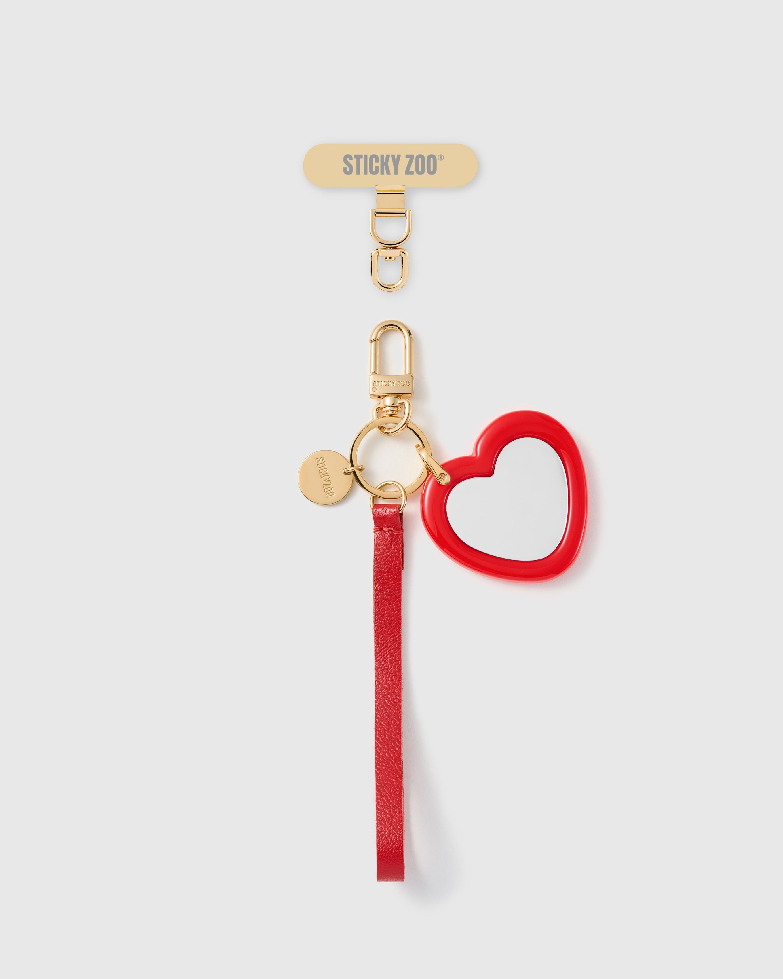 Handmade French Alran crimson red leather phone strap with glossy red heart-shaped pocket mirror and 18K gold STICKYZOO hardware