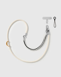 Ivory braided phone strap by STICKYZOO, worn as a wrist strap or cross-body, with silver-tone swivel hooks, a phone-tab connector and safety tether