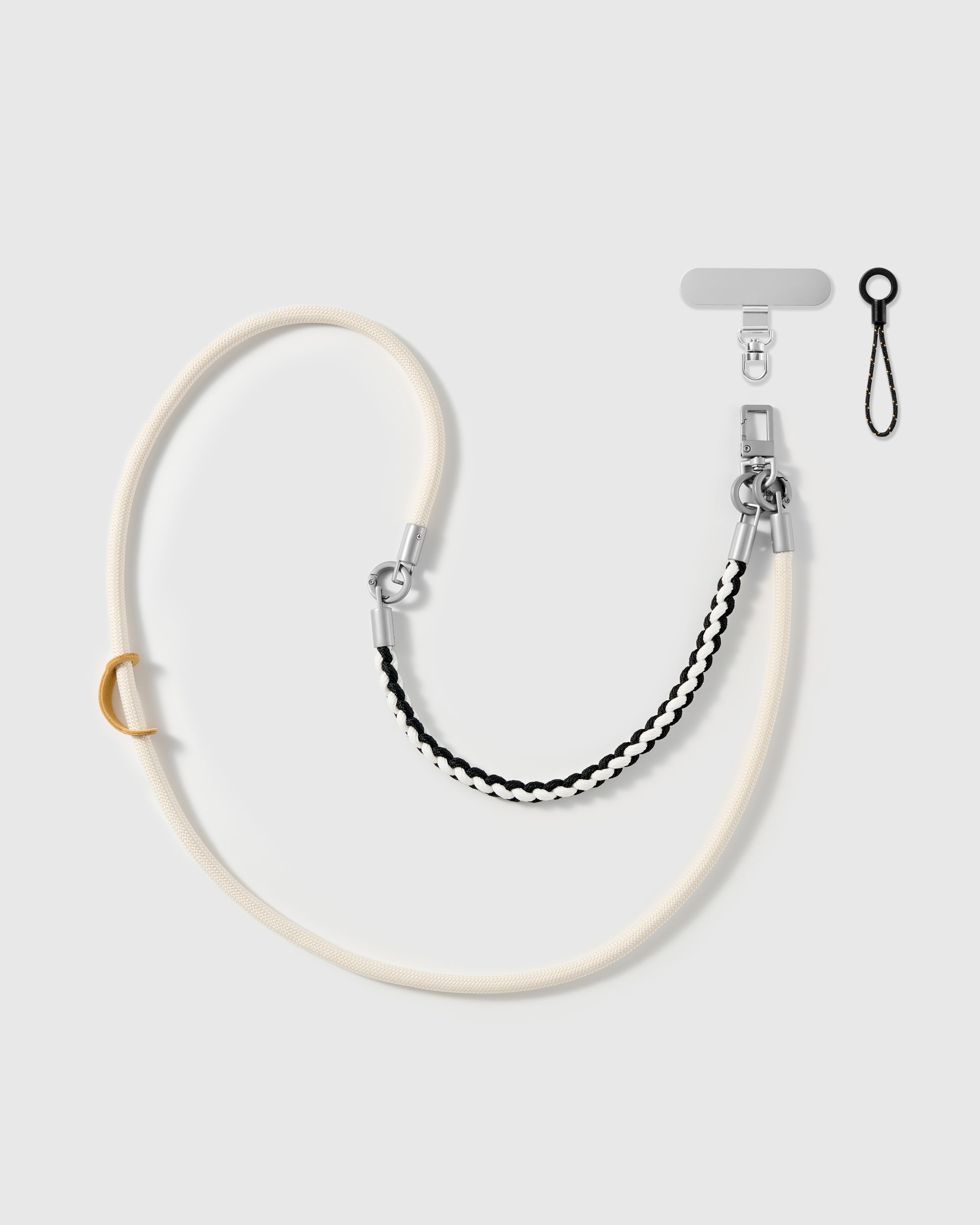 Ivory braided phone strap by STICKYZOO, worn as a wrist strap or cross-body, with silver-tone swivel hooks, a phone-tab connector and safety tether