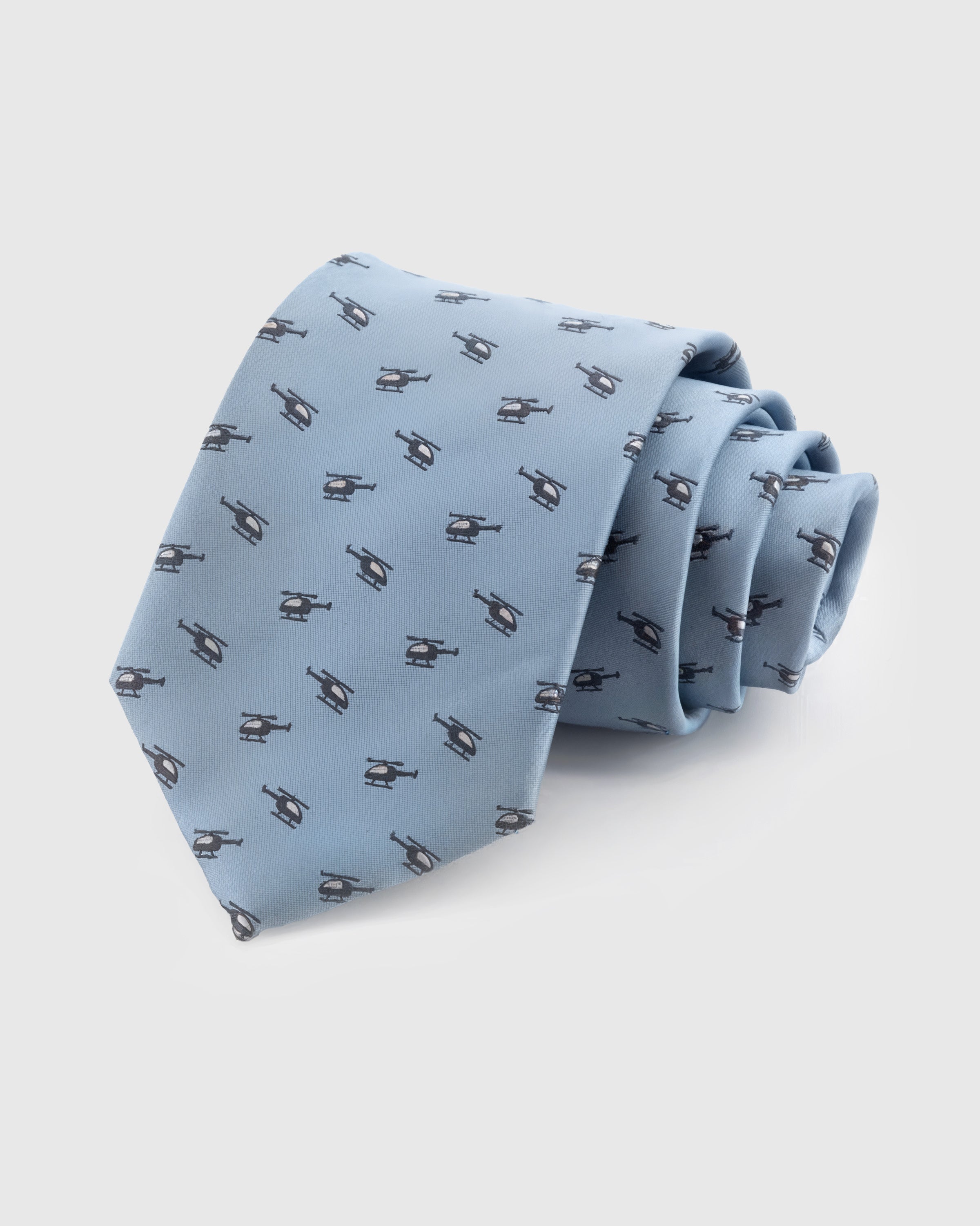 STICKYZOO Sky Helicopter Tie in hand-embroidered mulberry silk with slate helicopter motifs on pale blue ground, 45° bias-cut