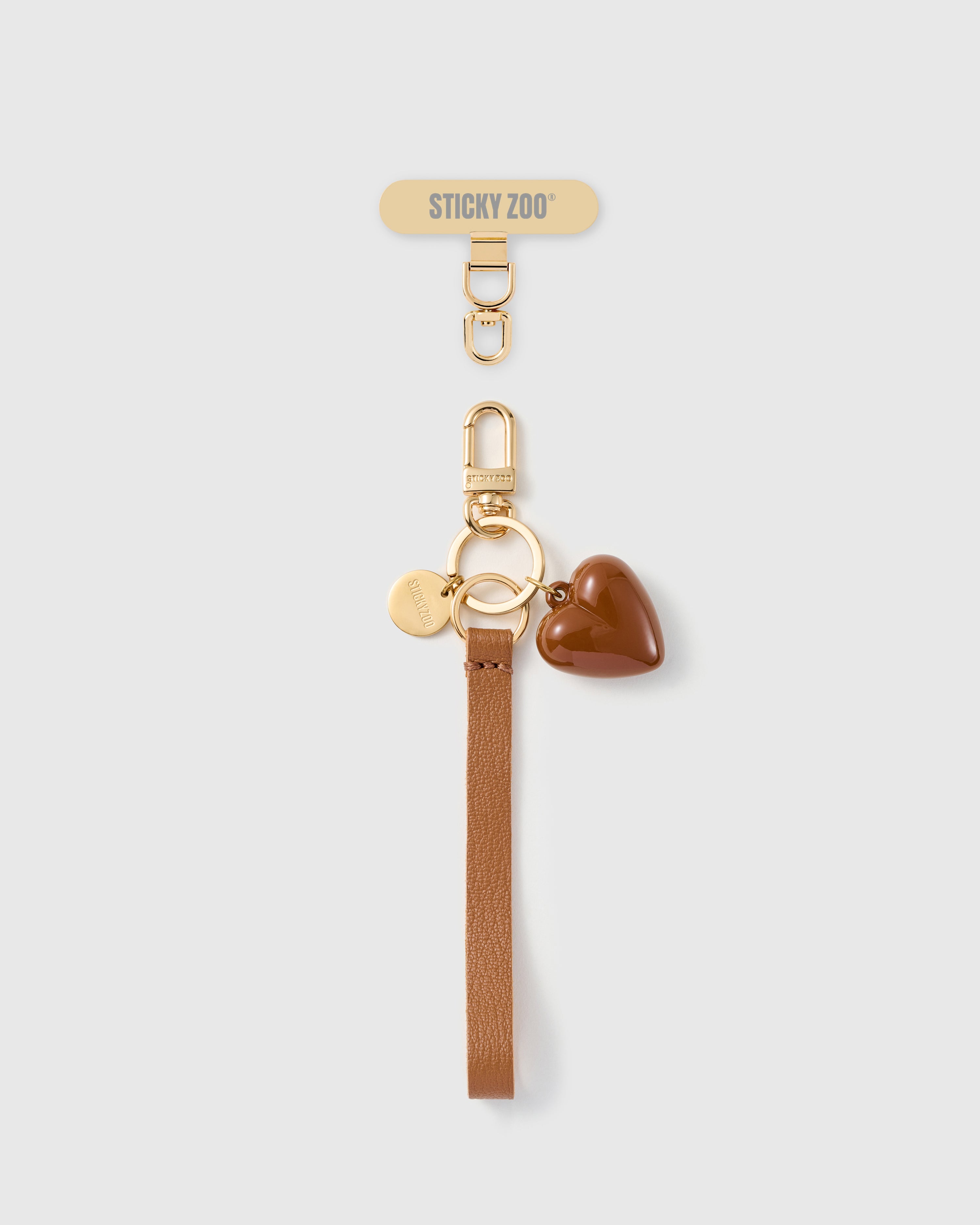 Handmade French Alran cocoa tan leather phone strap with glossy cocoa puff heart charm and 18K gold STICKYZOO hardware