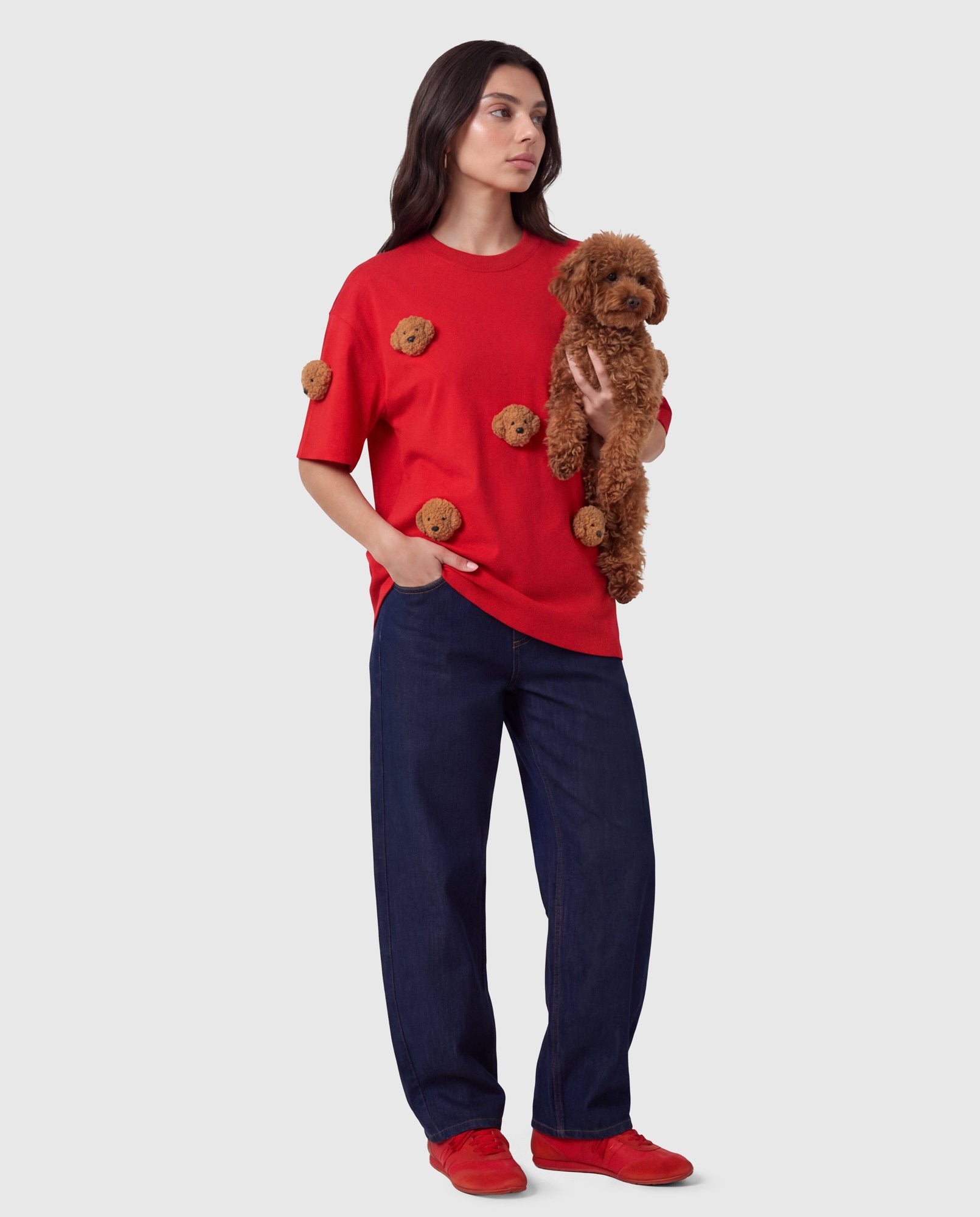 Model wearing STICKYZOO red Poodle Parade T-Shirt with a real poodle showing plush appliques