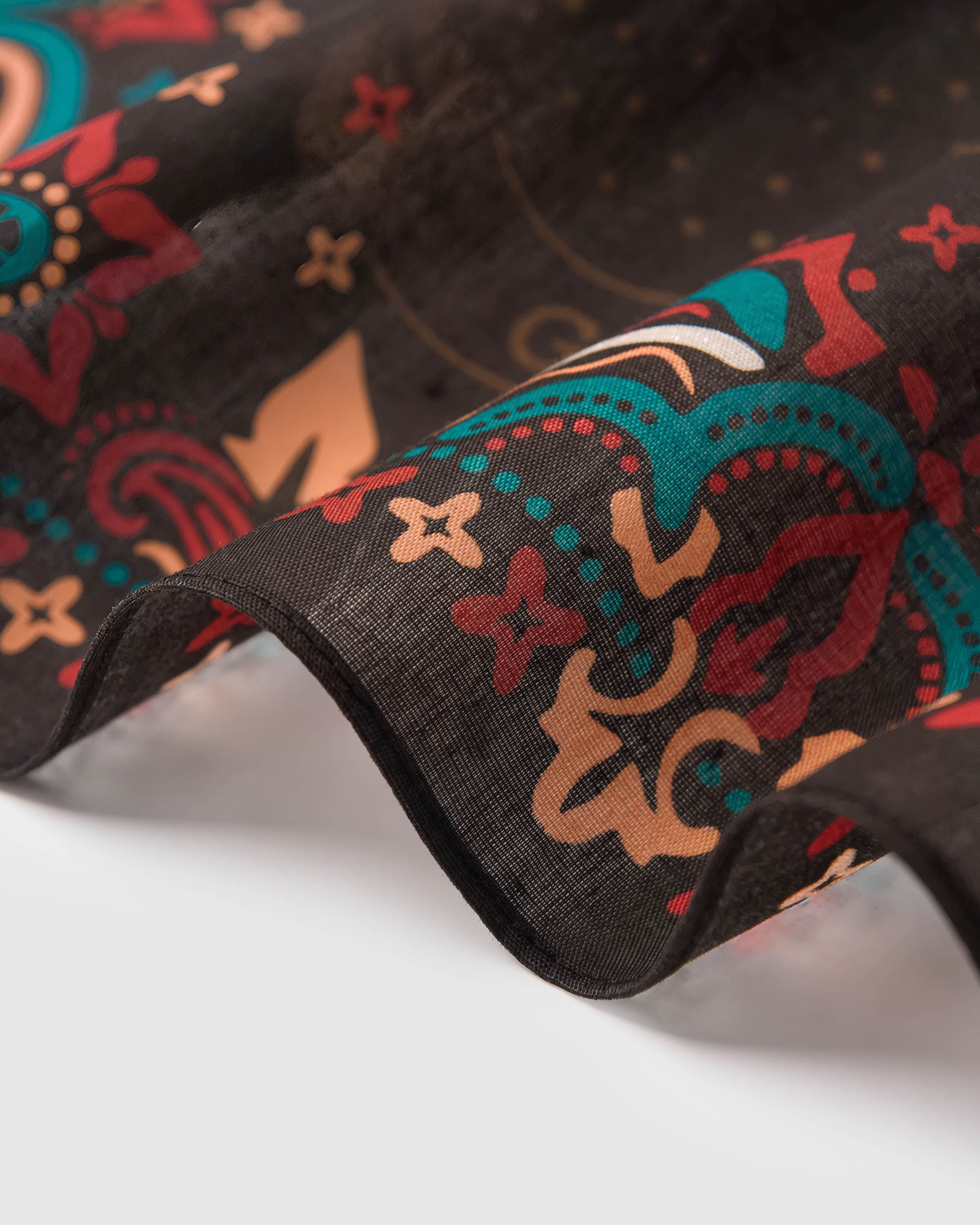 STICKYZOO calavera dance silk scarf showing the soft drape of pure silk against the paisley border