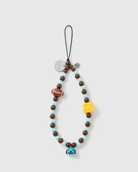 STICKYZOO beaded loop phone strap in cocoa-brown and sky-blue, laid flat with a football, yellow cheese bead, blue puppy bell and silver disc.