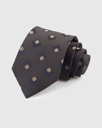 STICKYZOO GRAPHITE DIAMOND TIE — 100% mulberry silk with hand-embroidered navy and gold nested diamond motifs on warm graphite grey with nailhead weave ground