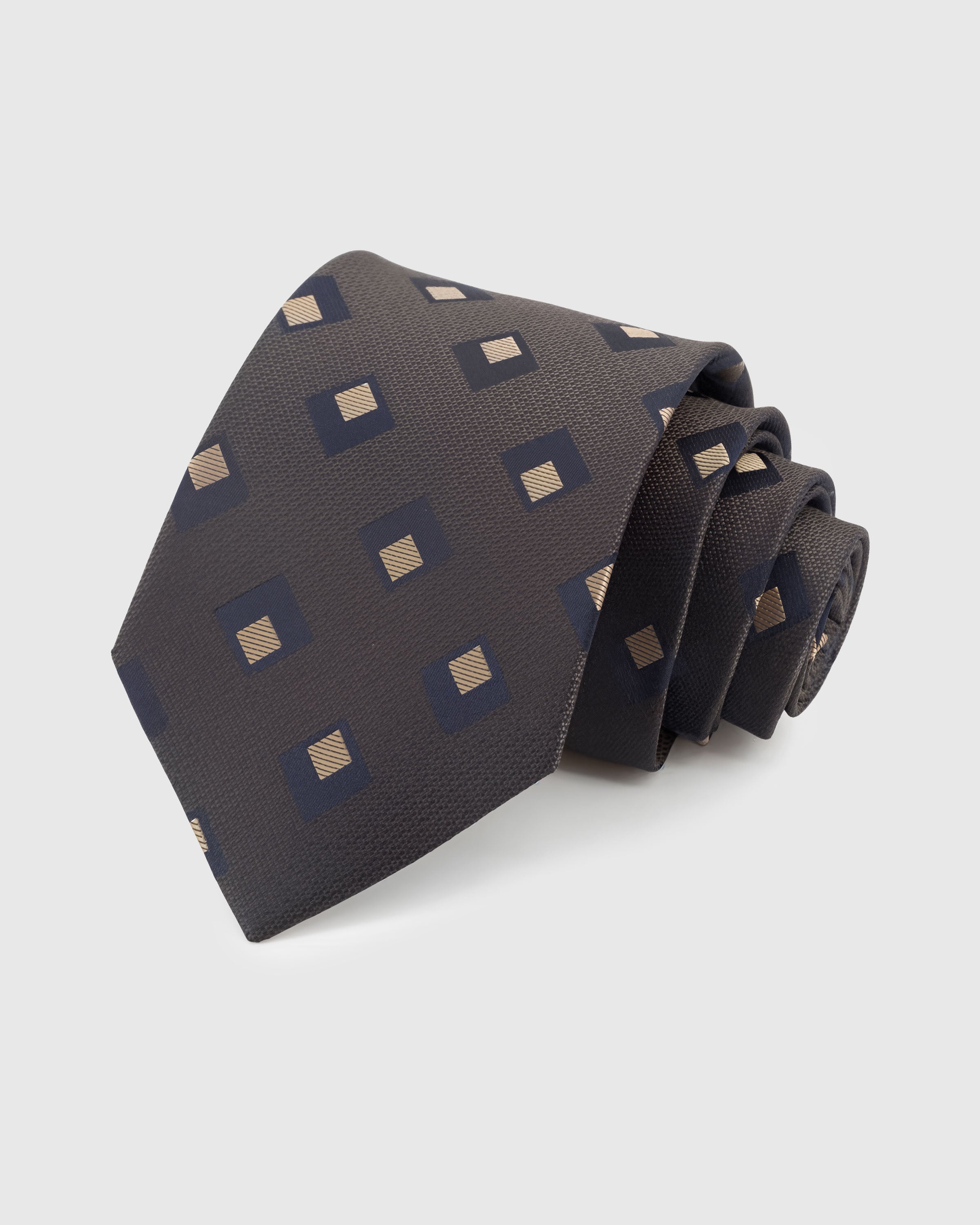 STICKYZOO GRAPHITE DIAMOND TIE — 100% mulberry silk with hand-embroidered navy and gold nested diamond motifs on warm graphite grey with nailhead weave ground
