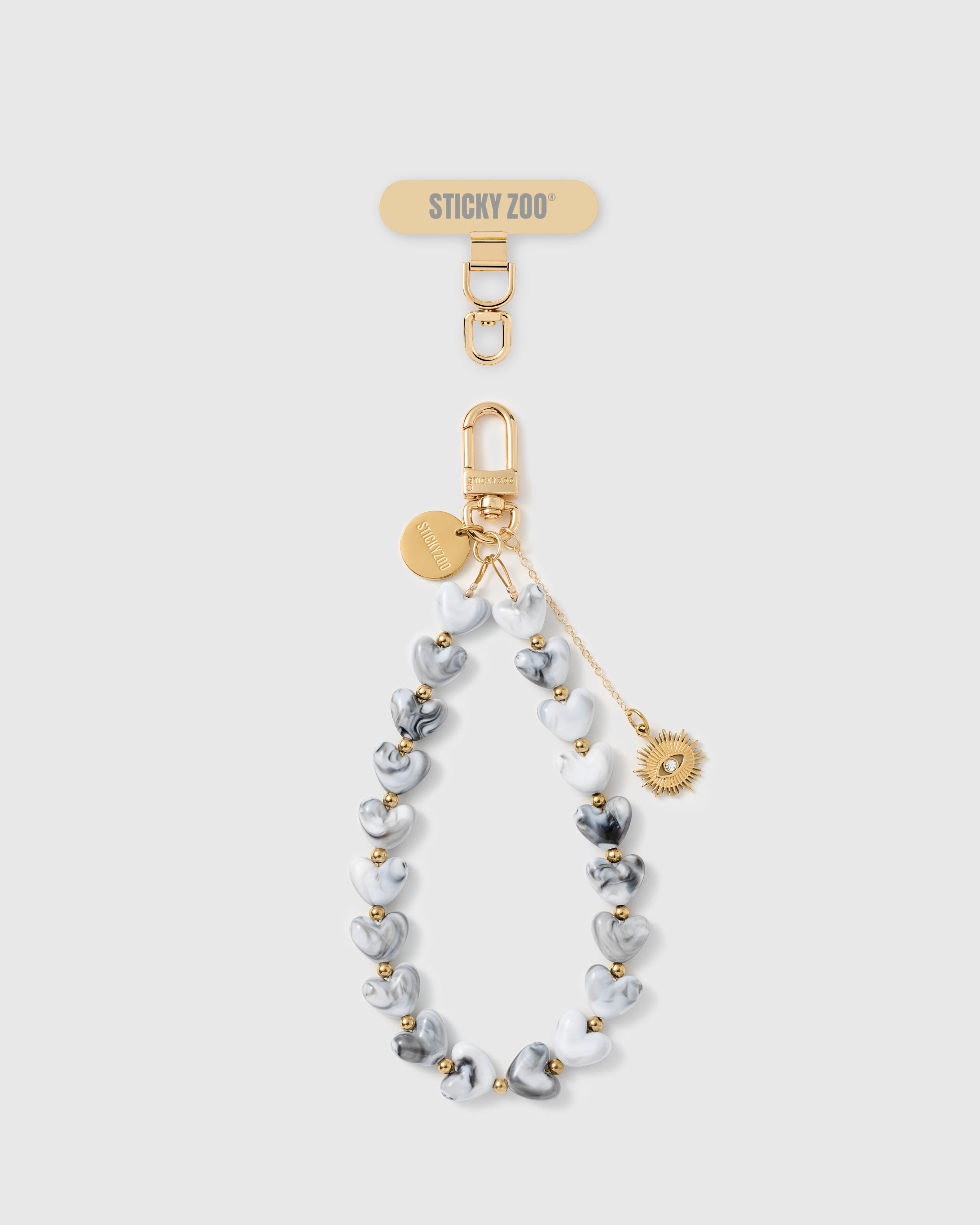 Handmade grey marble heart phone strap with gold sunburst eye amulet and 18K gold engraved STICKYZOO hardware