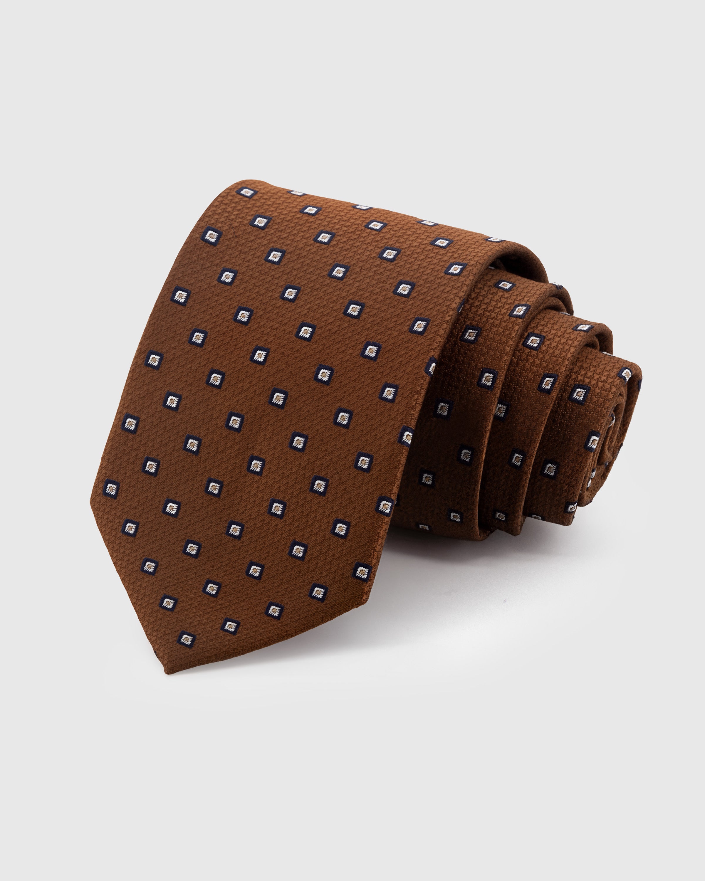 STICKYZOO Cognac Square Dot Tie in hand-embroidered mulberry silk with navy square dot motifs on piqué ground, 45° bias-cut Italian method