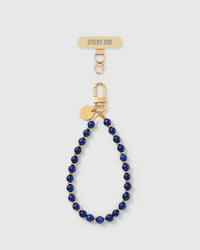 Handmade deep cobalt-blue real stone phone strap by STICKYZOO with 18K gold-plated engraved hardware