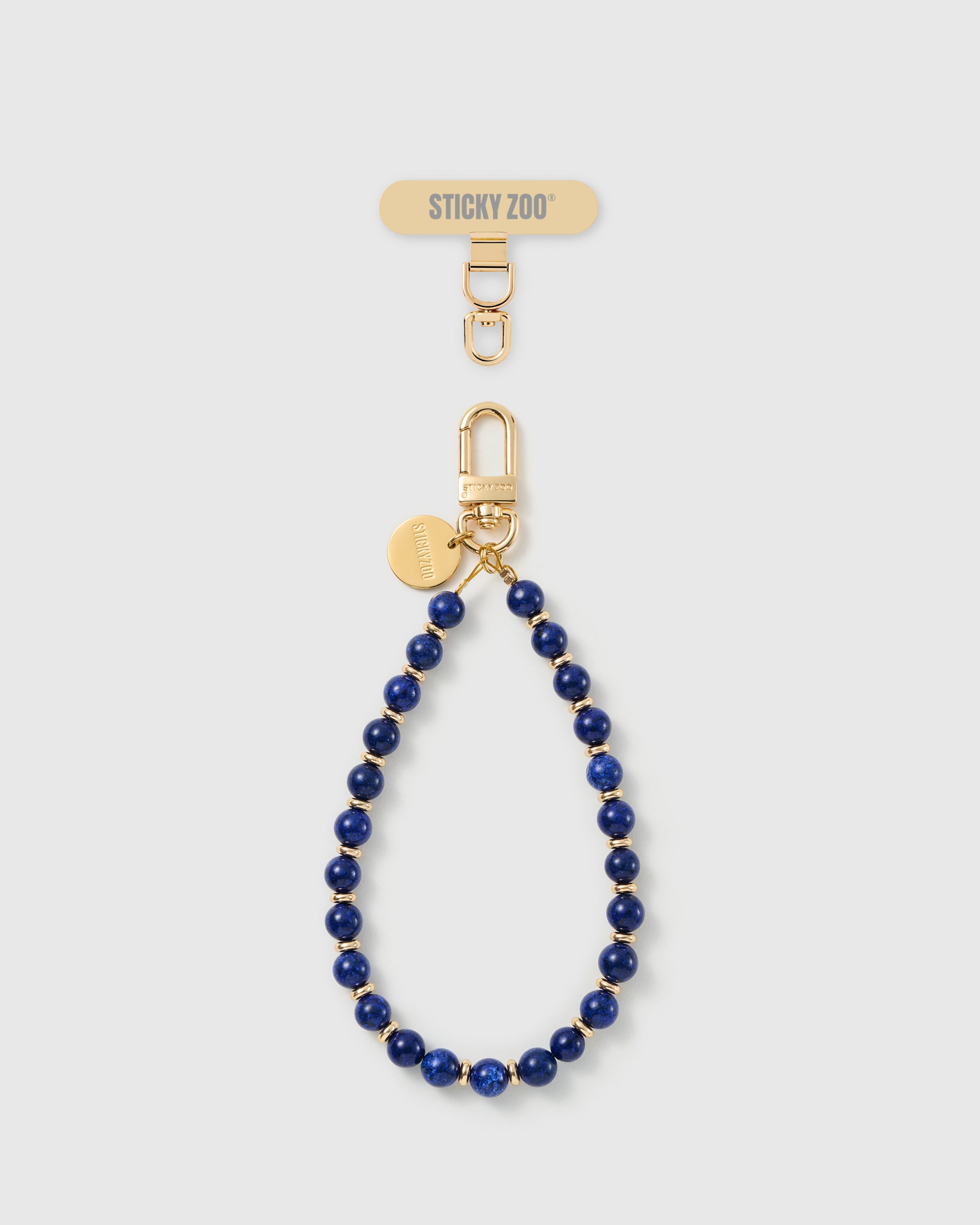 Handmade deep cobalt-blue real stone phone strap by STICKYZOO with 18K gold-plated engraved hardware