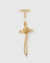 Champagne gold braided cord phone strap with sculptural bow knot and 18K gold-plated engraved hardware by STICKYZOO