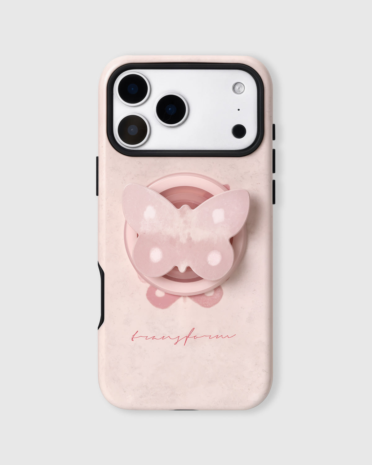Pale pink phone case with a pearlescent butterfly MagSafe grip and red "transform" script by STICKYZOO