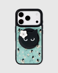 STICKYZOO midnight cat phone case in mint with white roses, scattered black cats, and a black cat-face MagSafe pop-grip