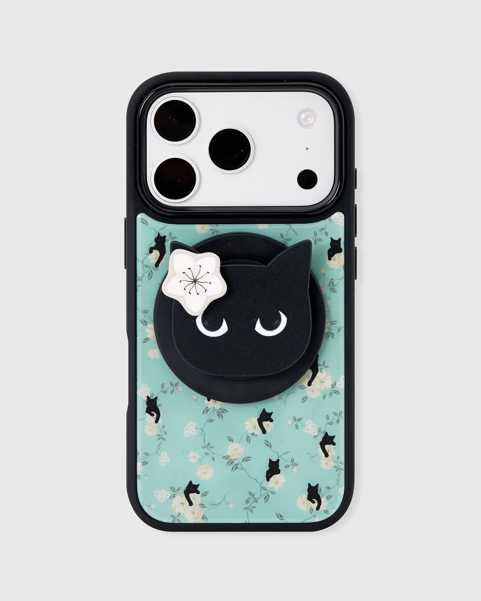 STICKYZOO midnight cat phone case in mint with white roses, scattered black cats, and a black cat-face MagSafe pop-grip