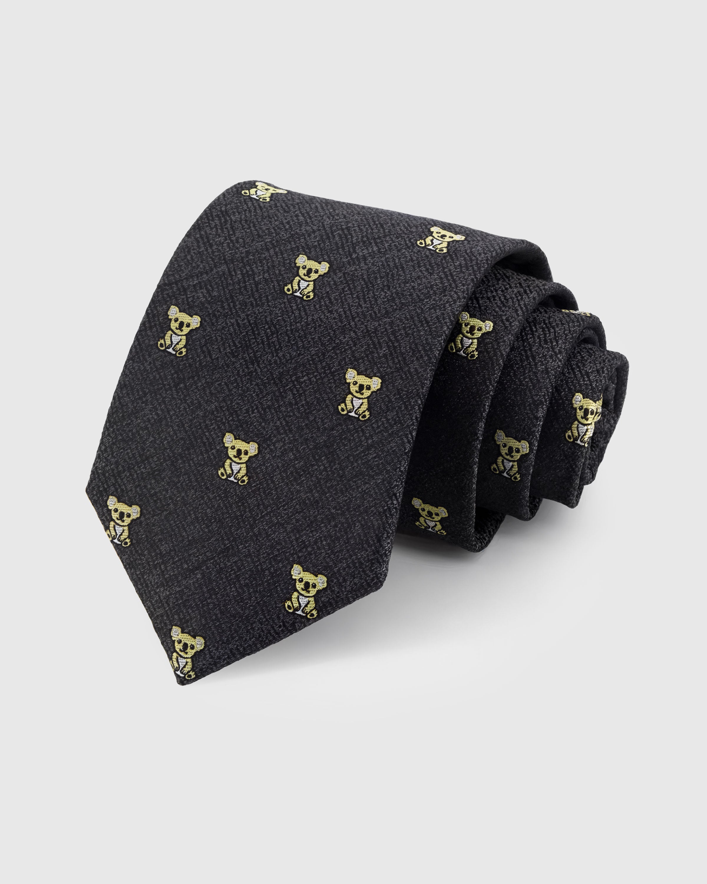 STICKYZOO CHARCOAL KOALA TIE — 100% mulberry silk with hand-embroidered gold-toned embroidered koala motifs on dark charcoal with herringbone texture ground