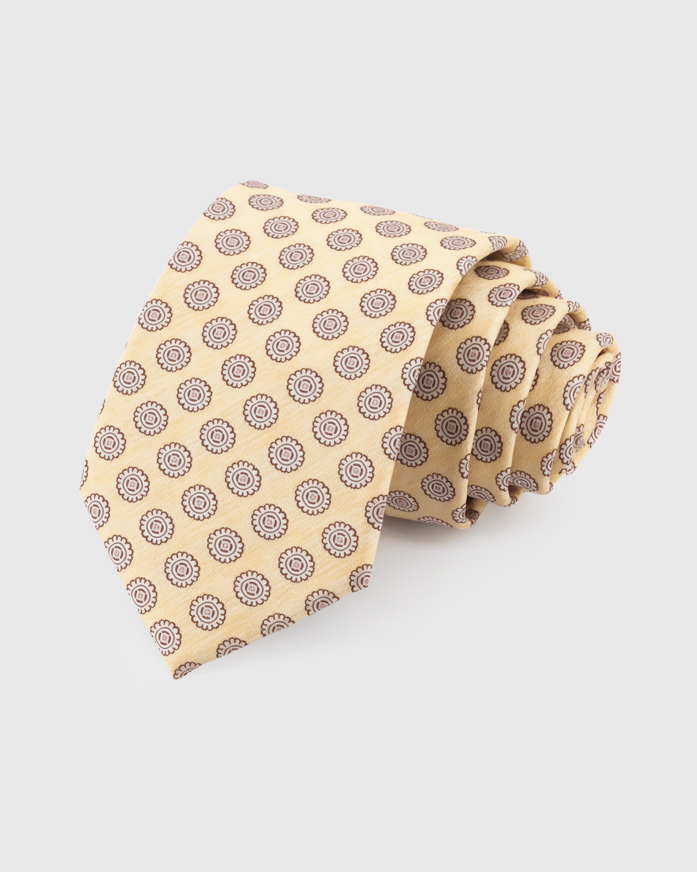 STICKYZOO Champagne Medallion Tie in hand-embroidered mulberry silk with walnut medallion circles on pale gold ground, 45° bias-cut